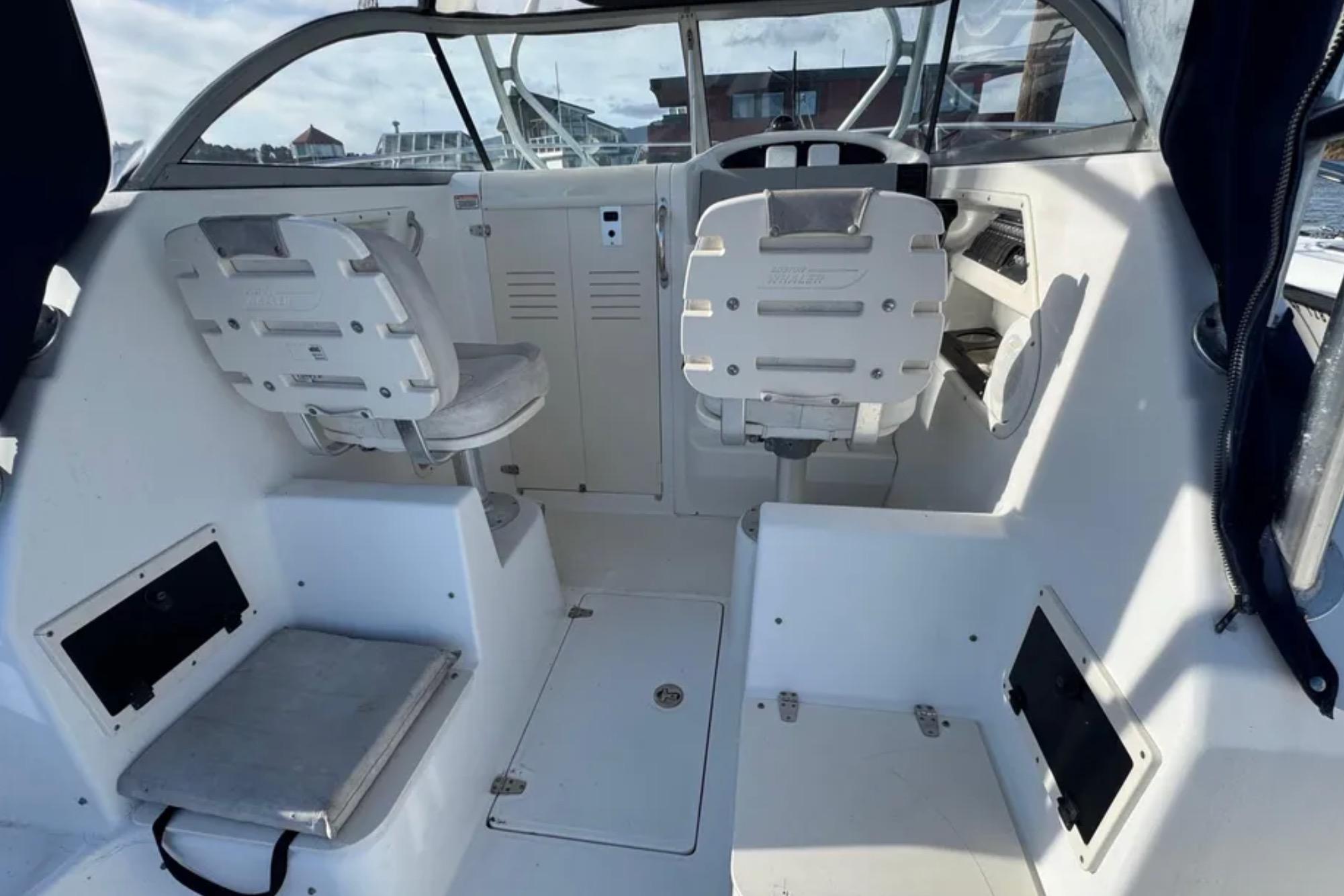 2004 Boston Whaler 255 Conquest boat interior with helm and seating area.