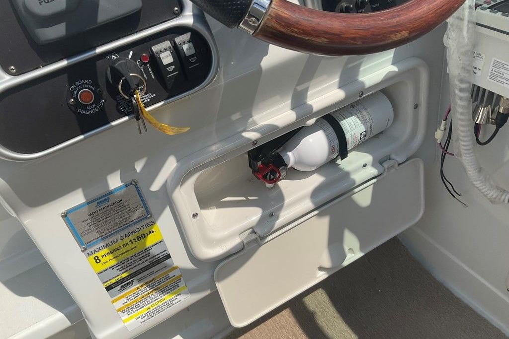 2015 Crownline 236 SC boat dashboard with fire extinguisher and capacity label.