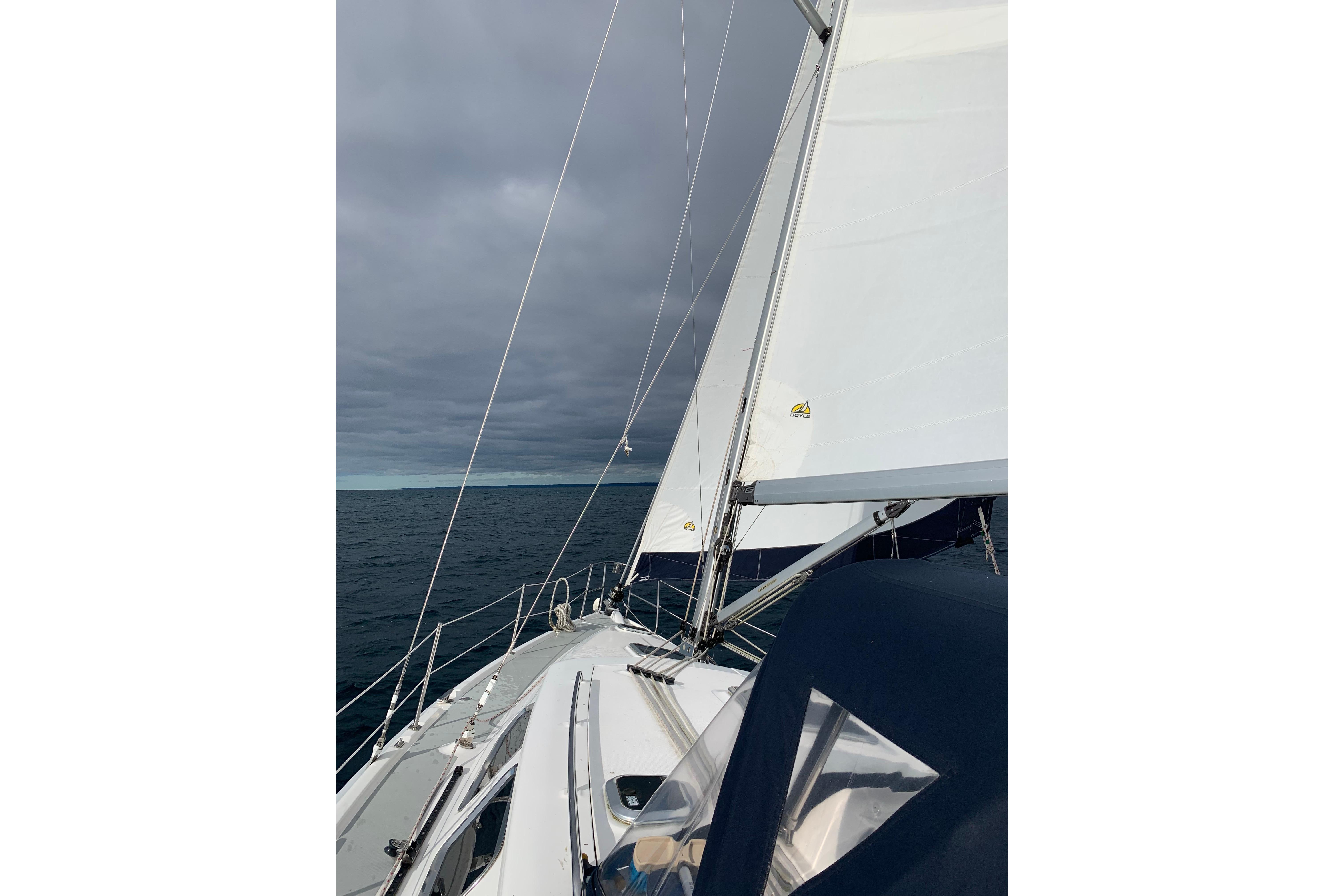 Sailing on a 2007 Hunter 41 Deck Salon under cloudy skies.