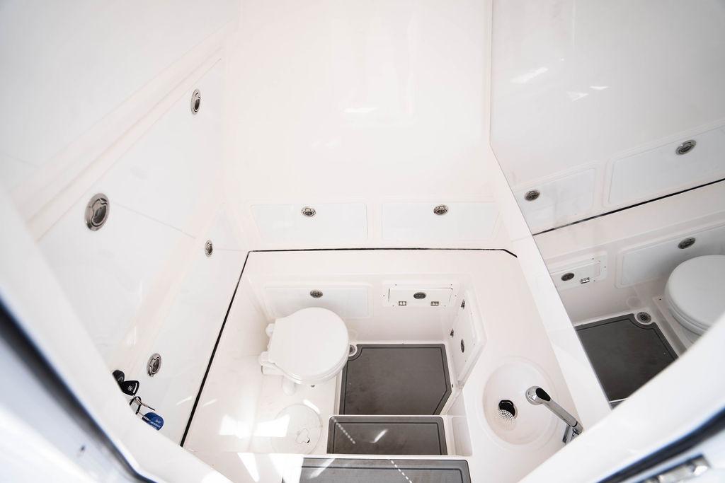 Interior of 2027 Reef Runner 340 boat featuring a compact, modern bathroom design.