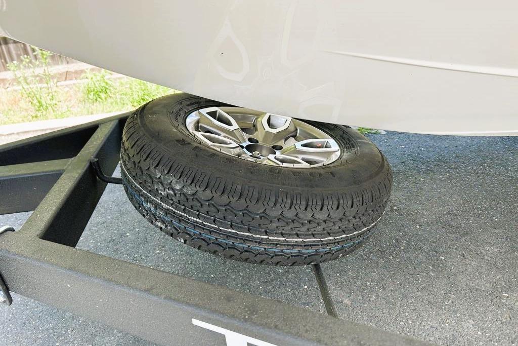 2026 Tahoe 2150 boat on trailer with spare tire underneath.