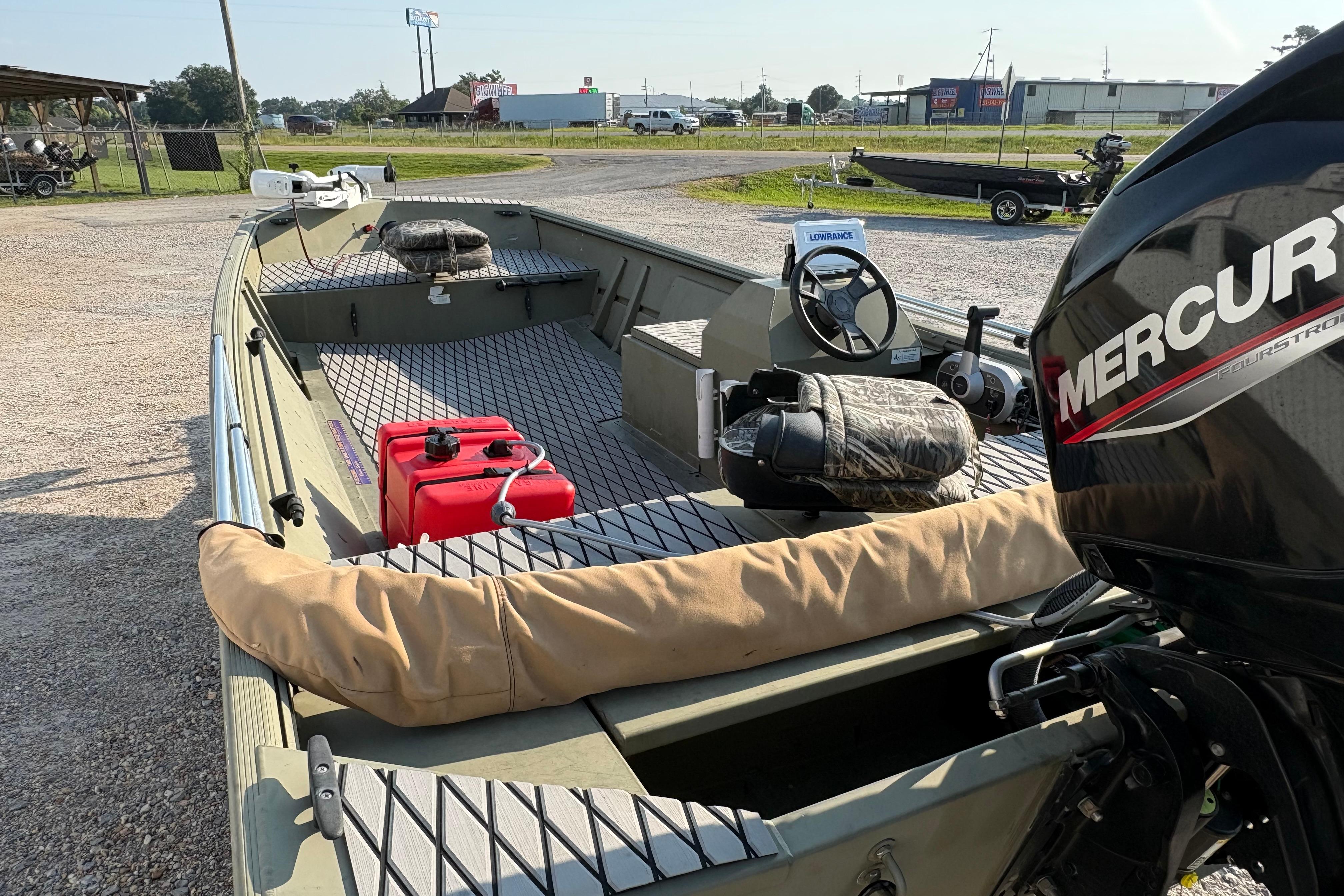 2019 Lowe Roughneck 1860SC boat with Mercury engine, red fuel tank, and camo seating.