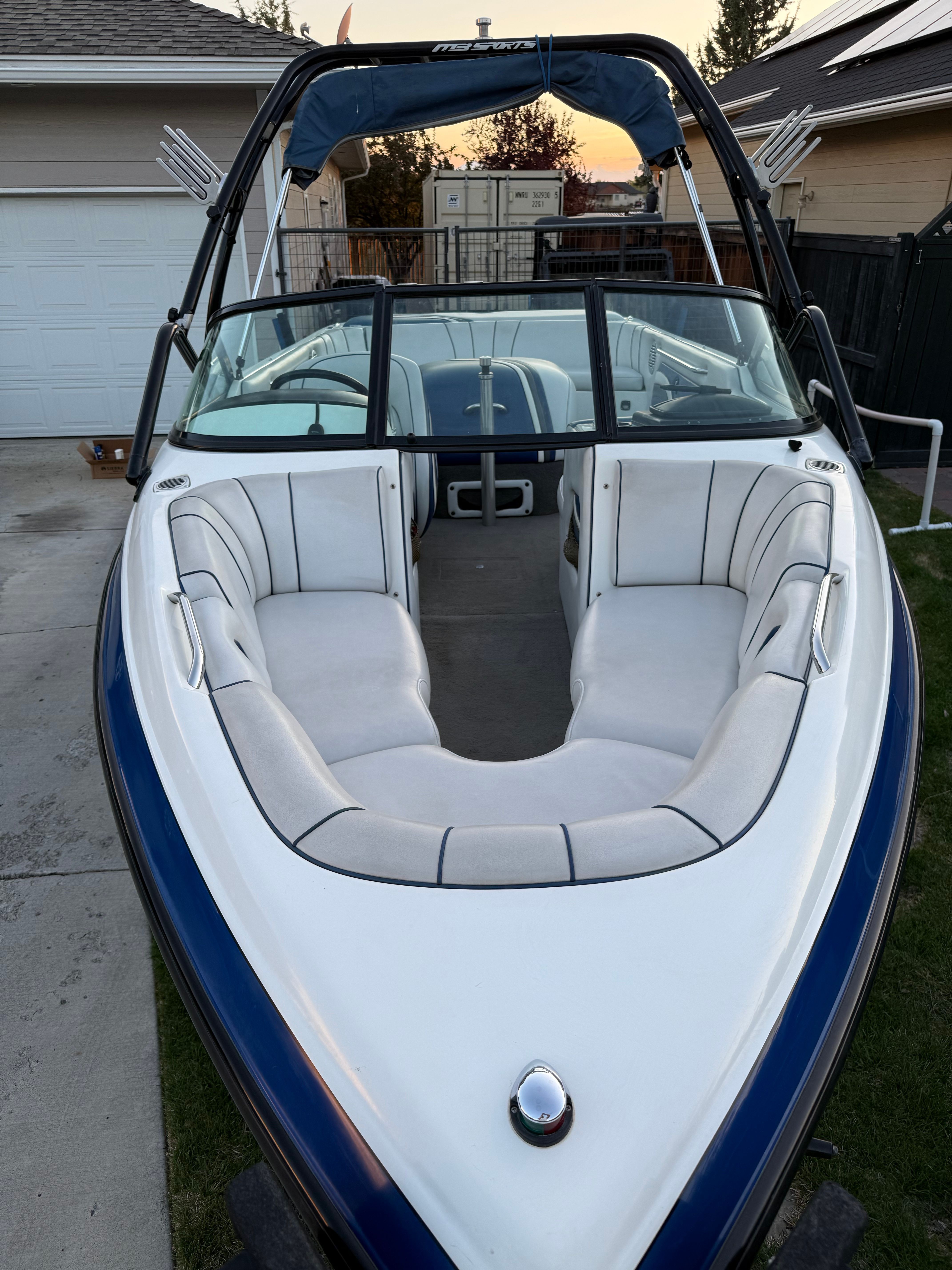 2004 MB Sports 220 boat with white interior and blue accents.