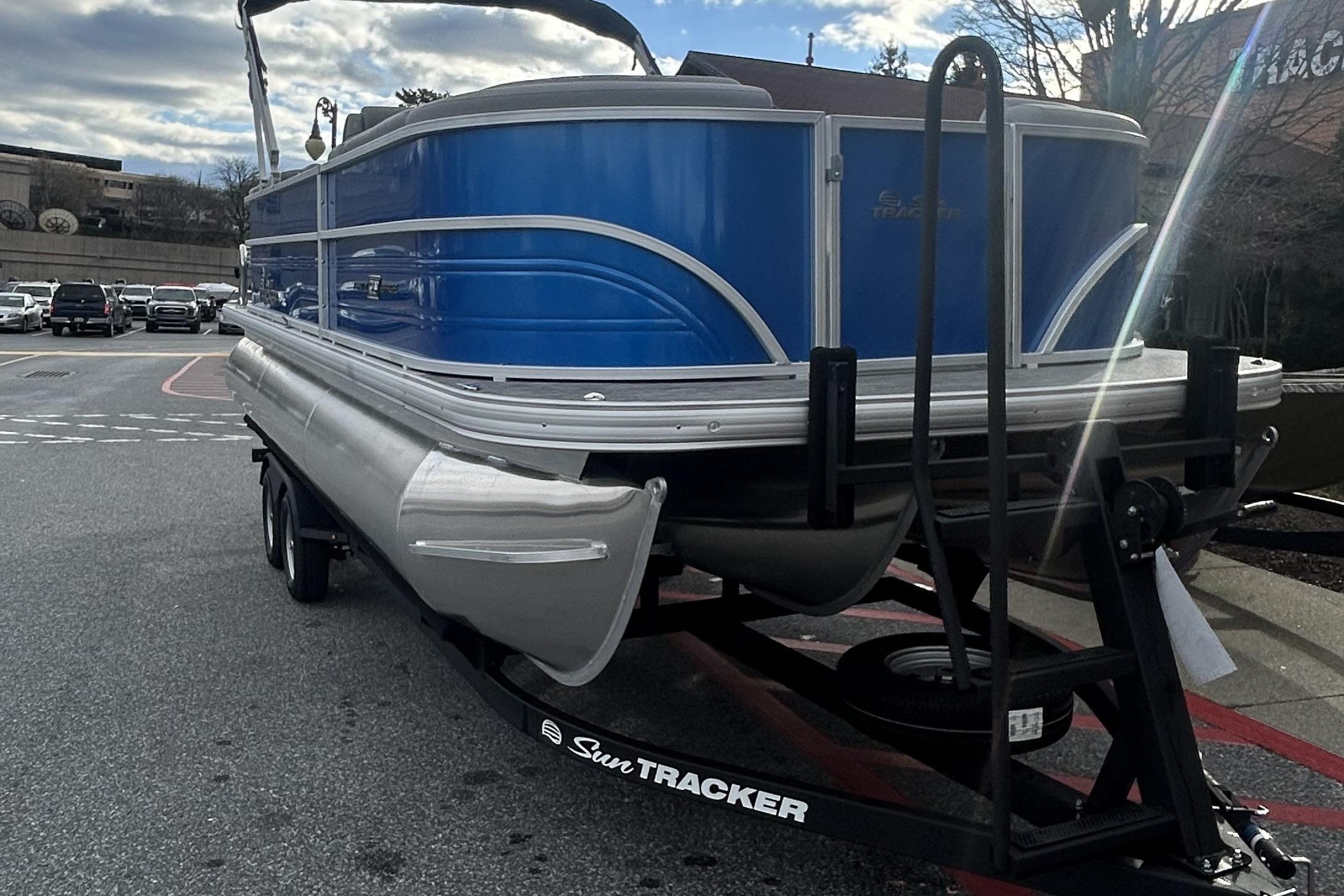 2026 Sun Tracker Party Barge 22 XP3 pontoon boat on trailer, parked outdoors.