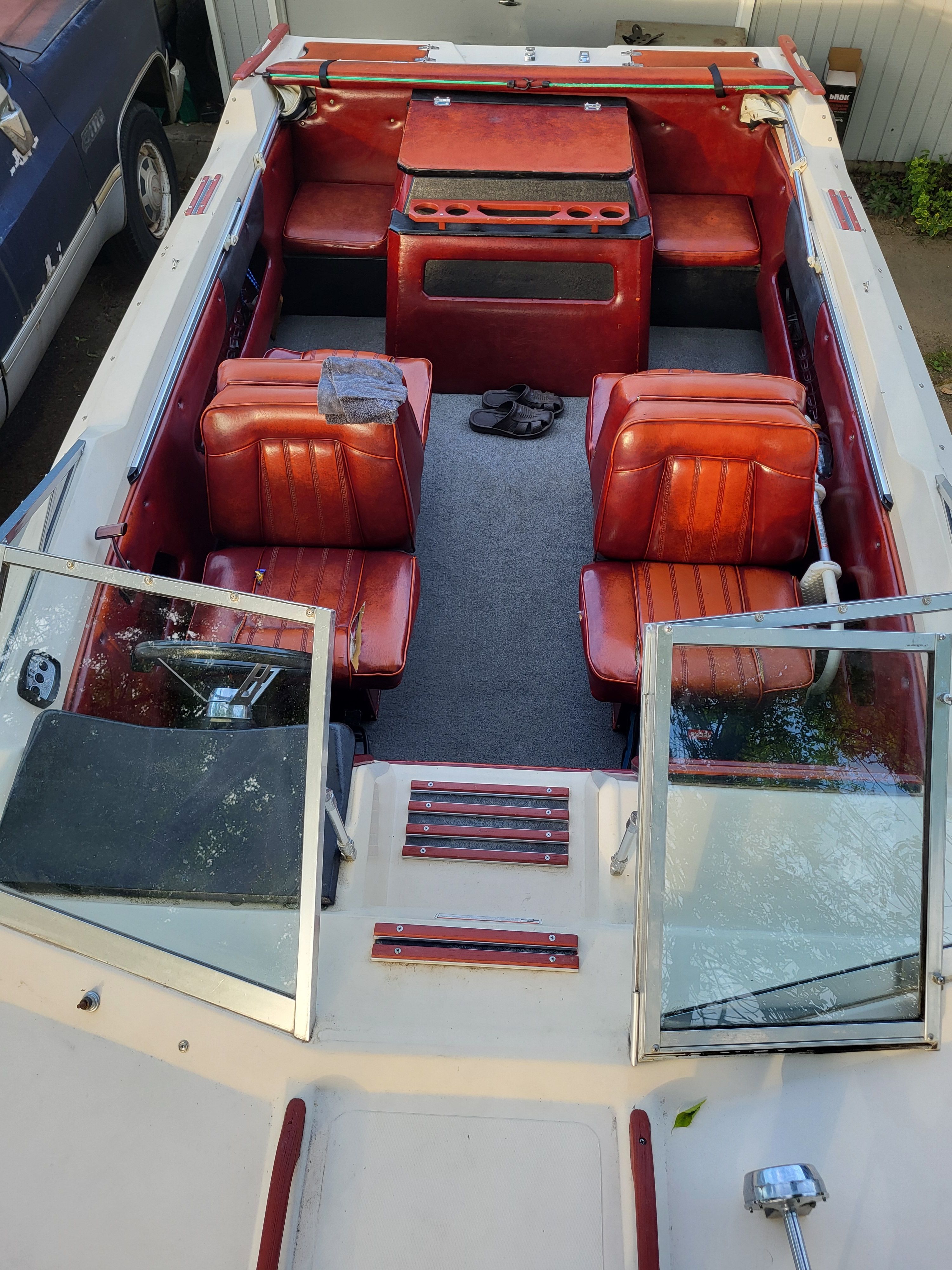 Interior of a 1977 Bayliner Jamaica boat with red leather seats.