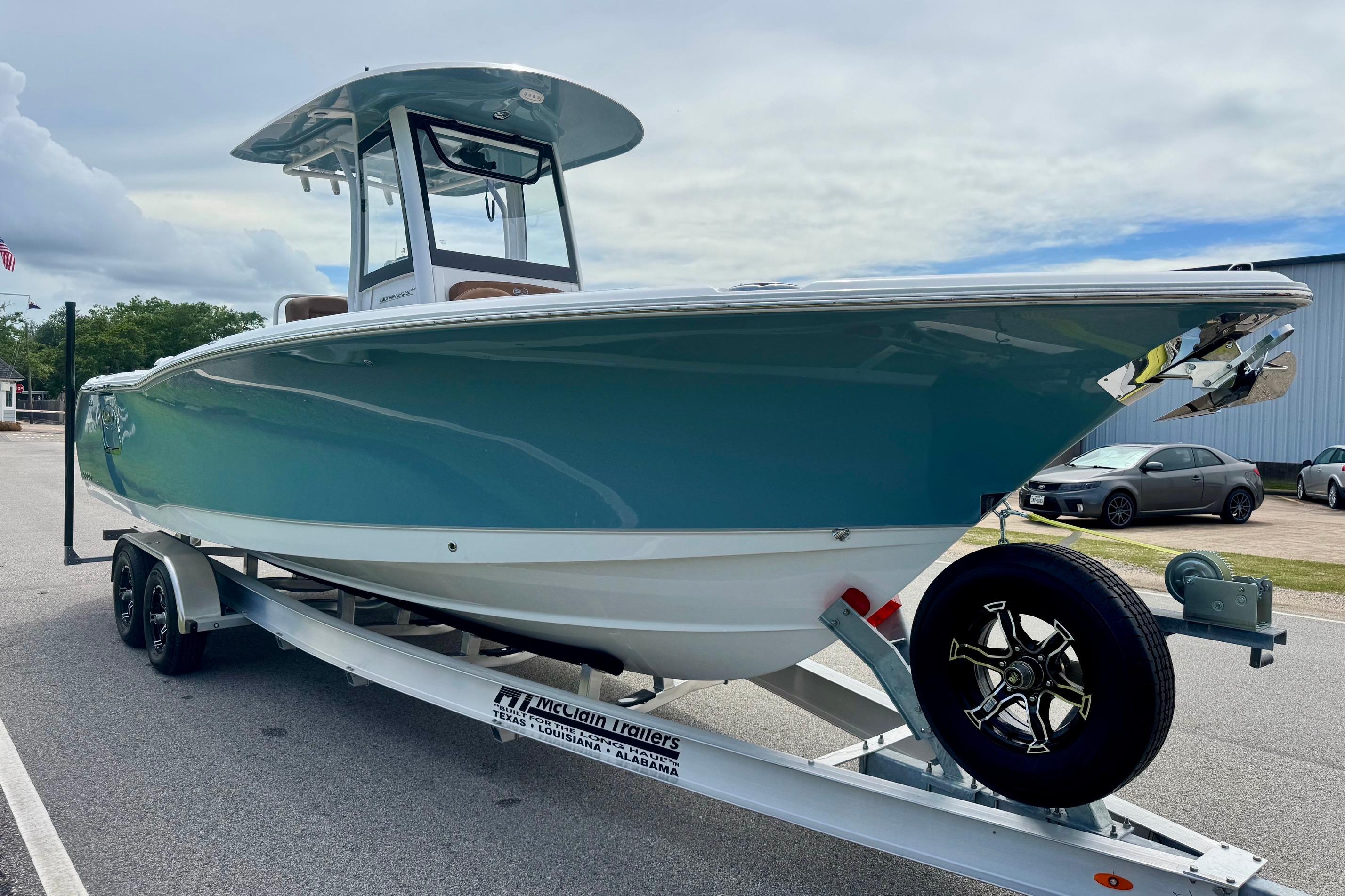 2026 Sea Hunt Ultra 275 SE boat on trailer, parked outdoors.