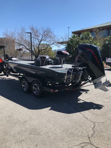 2025 Ranger ALPHA 208 boat with outboard motor on a trailer, parked outdoors.