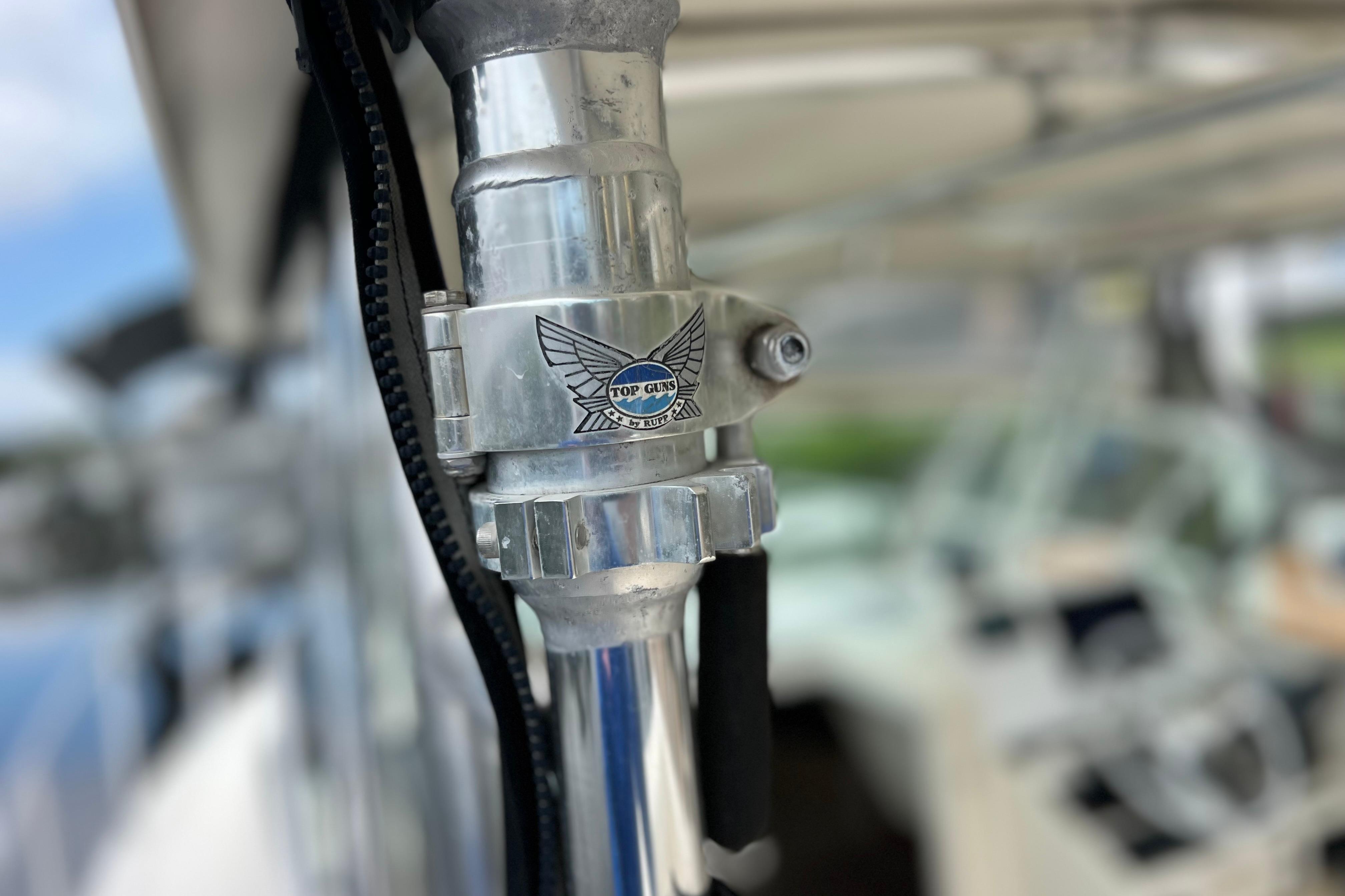 Close-up of a 2005 Pursuit 3070 Offshore boat component with "Top Guns" logo.