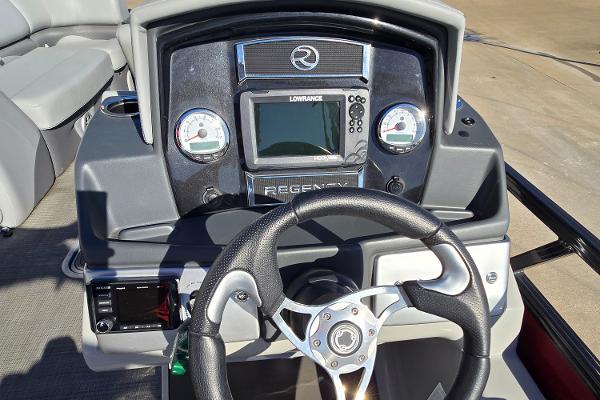 2023 Regency 250 DL3 boat dashboard with steering wheel and navigation controls.