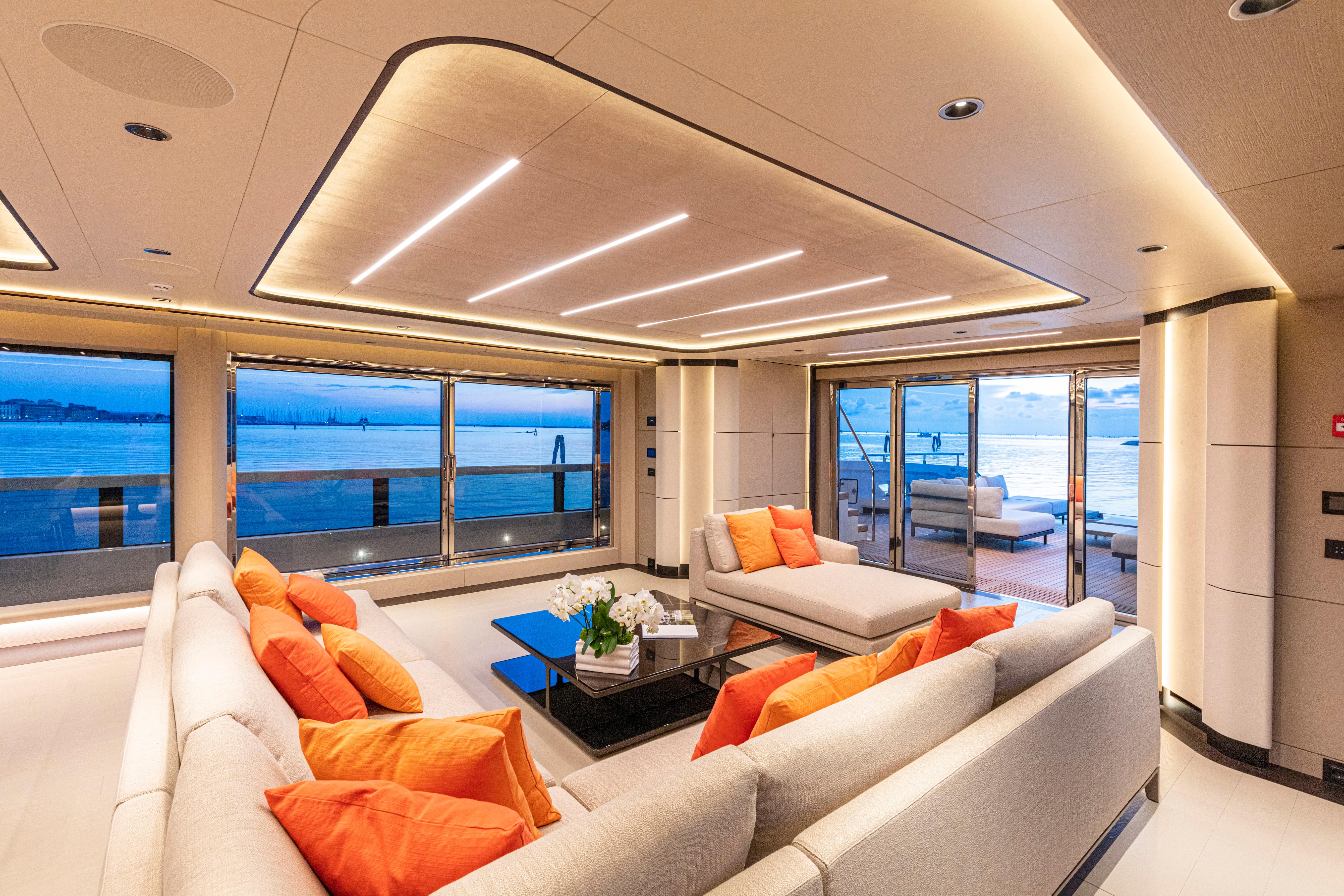 Luxurious interior of 2027 Ocean King Ducale 120 yacht with modern seating and ocean view.