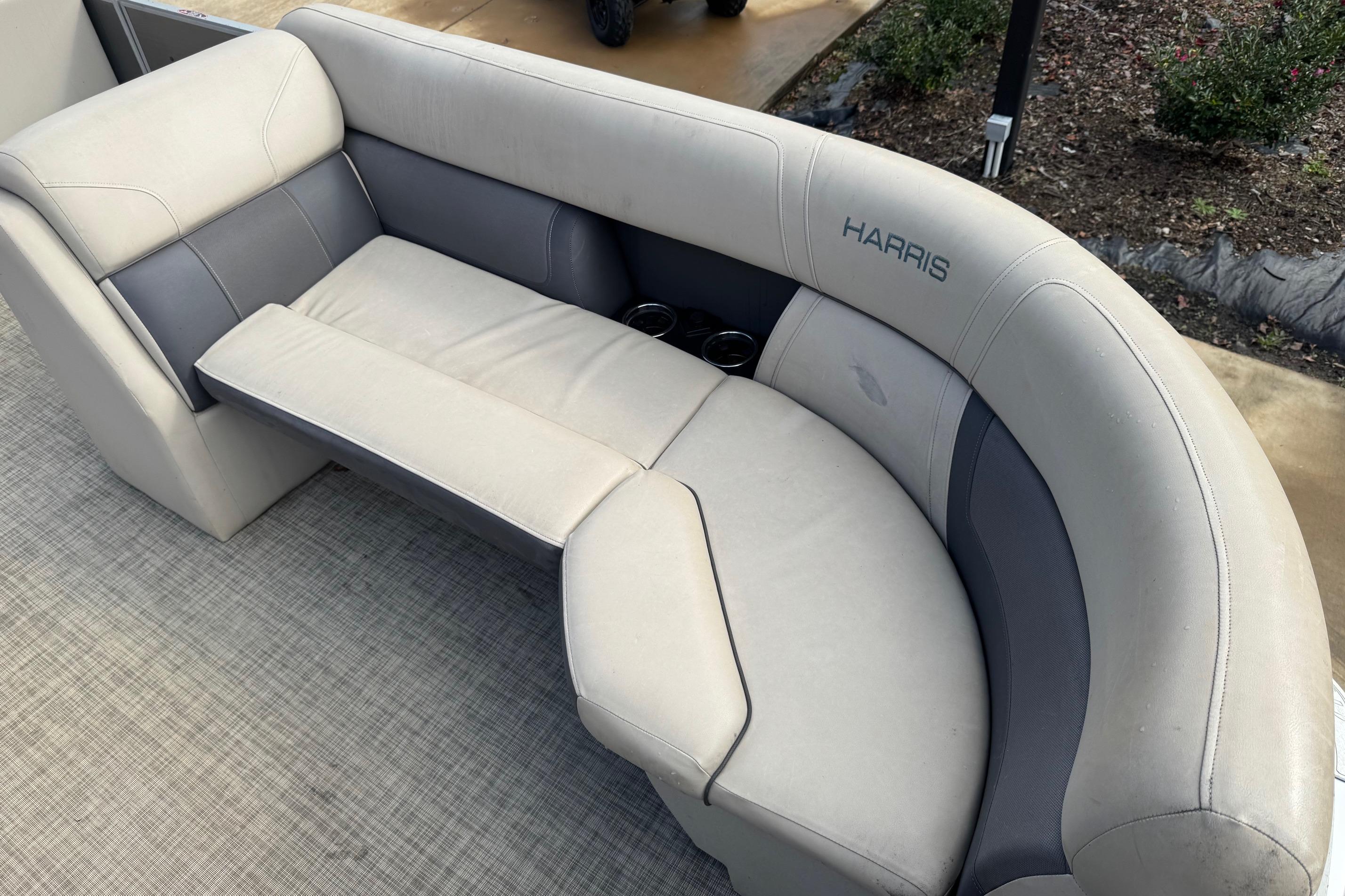 2023 Harris Cruiser 230 boat seating with beige and gray upholstery, featuring cup holders.