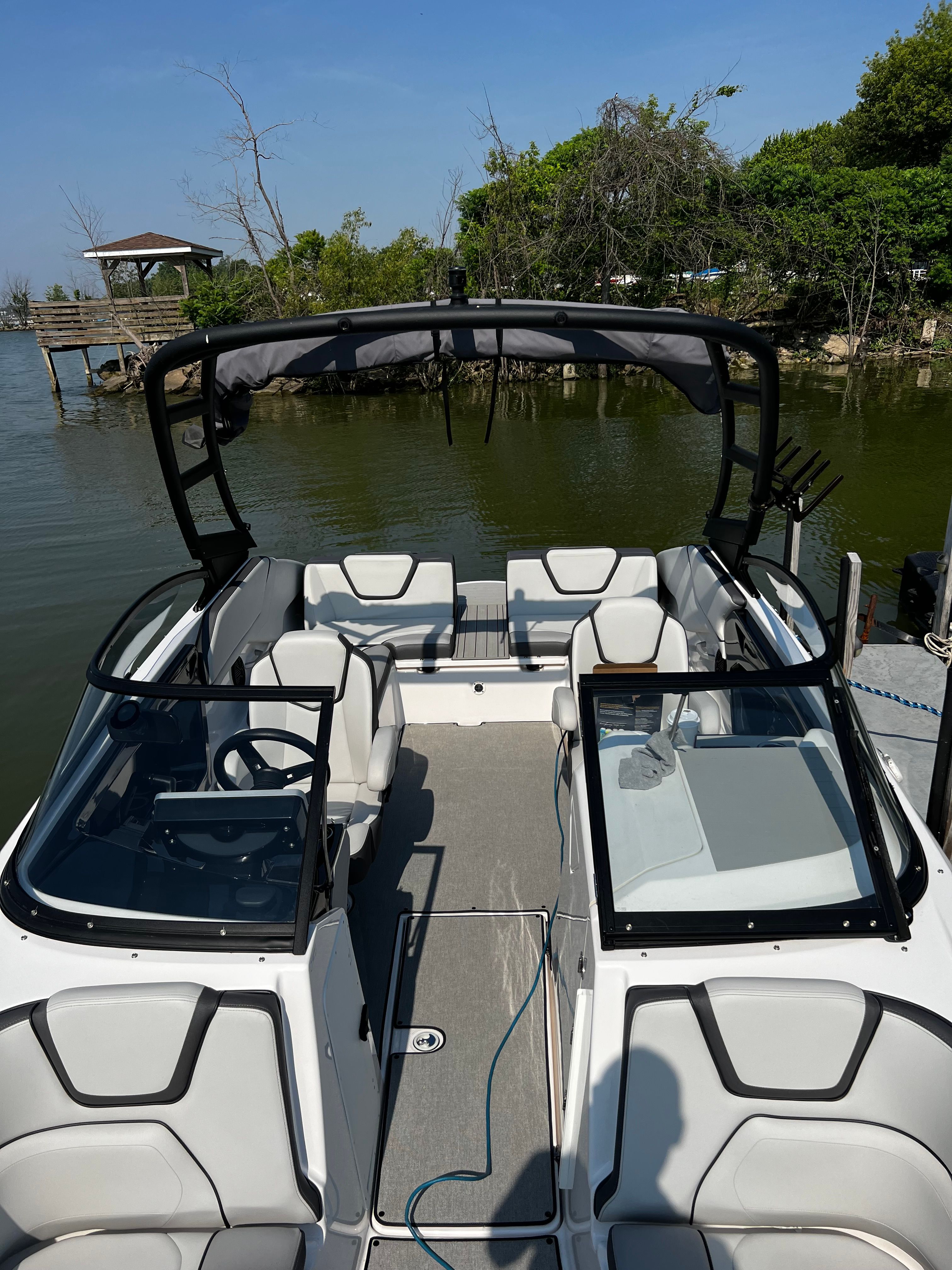 Interior view of a 2021 Yamaha AR250 boat by the lake.