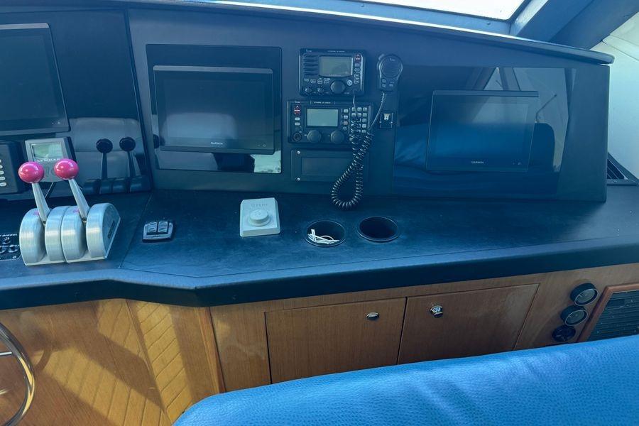 Control panel of a 2002 Viking 61 Enclosed Bridge yacht with navigation equipment.