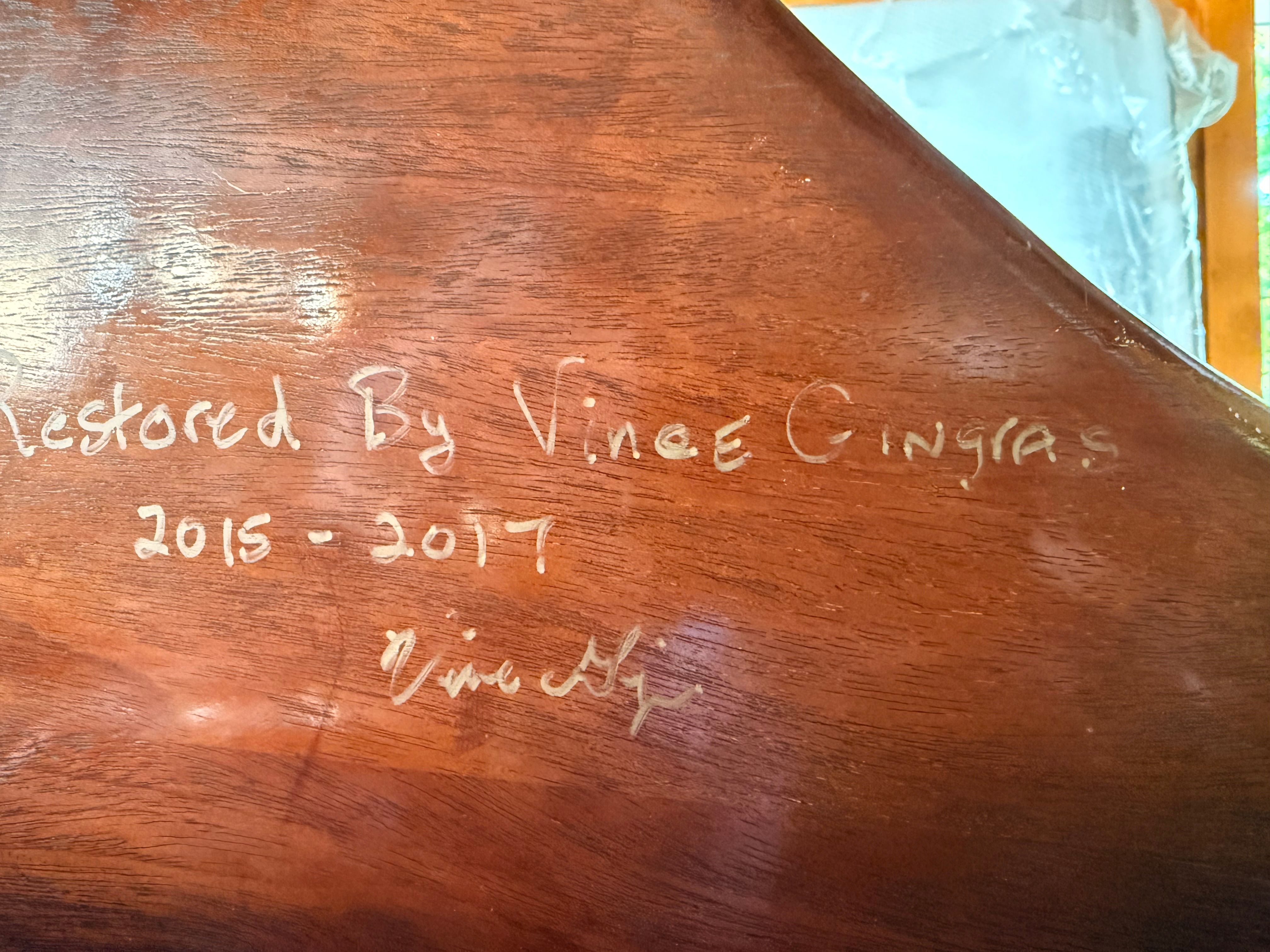 Close-up of a restored boat part with a handwritten dedication.