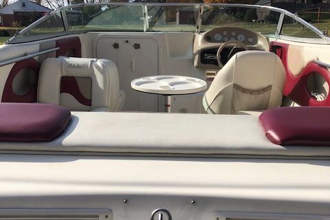 Interior of a 1999 Rinker 212 Fiesta Vee boat with seating area.