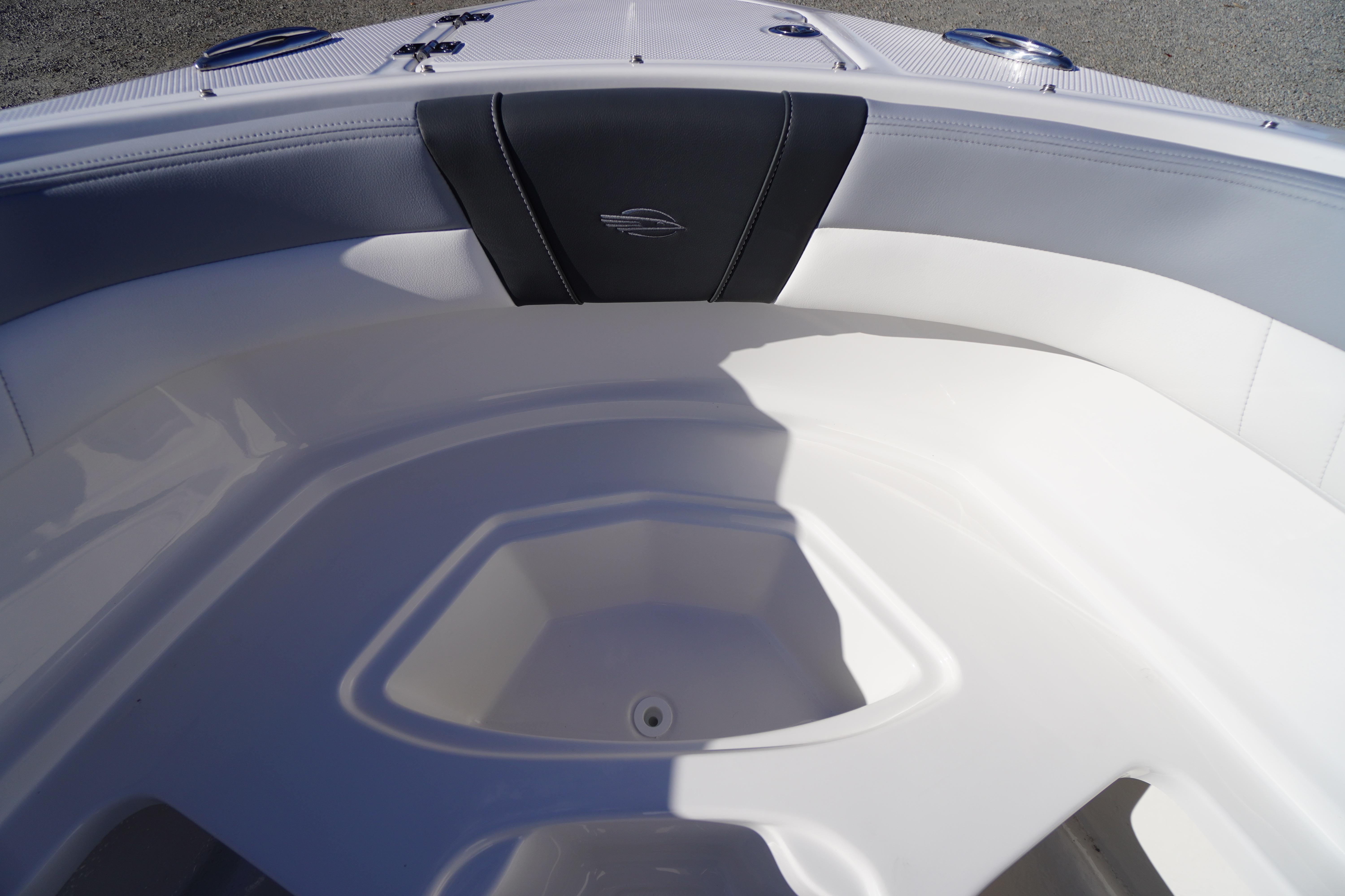 Interior view of 2026 Chaparral 23 SSi boat, featuring sleek white seating and modern design.