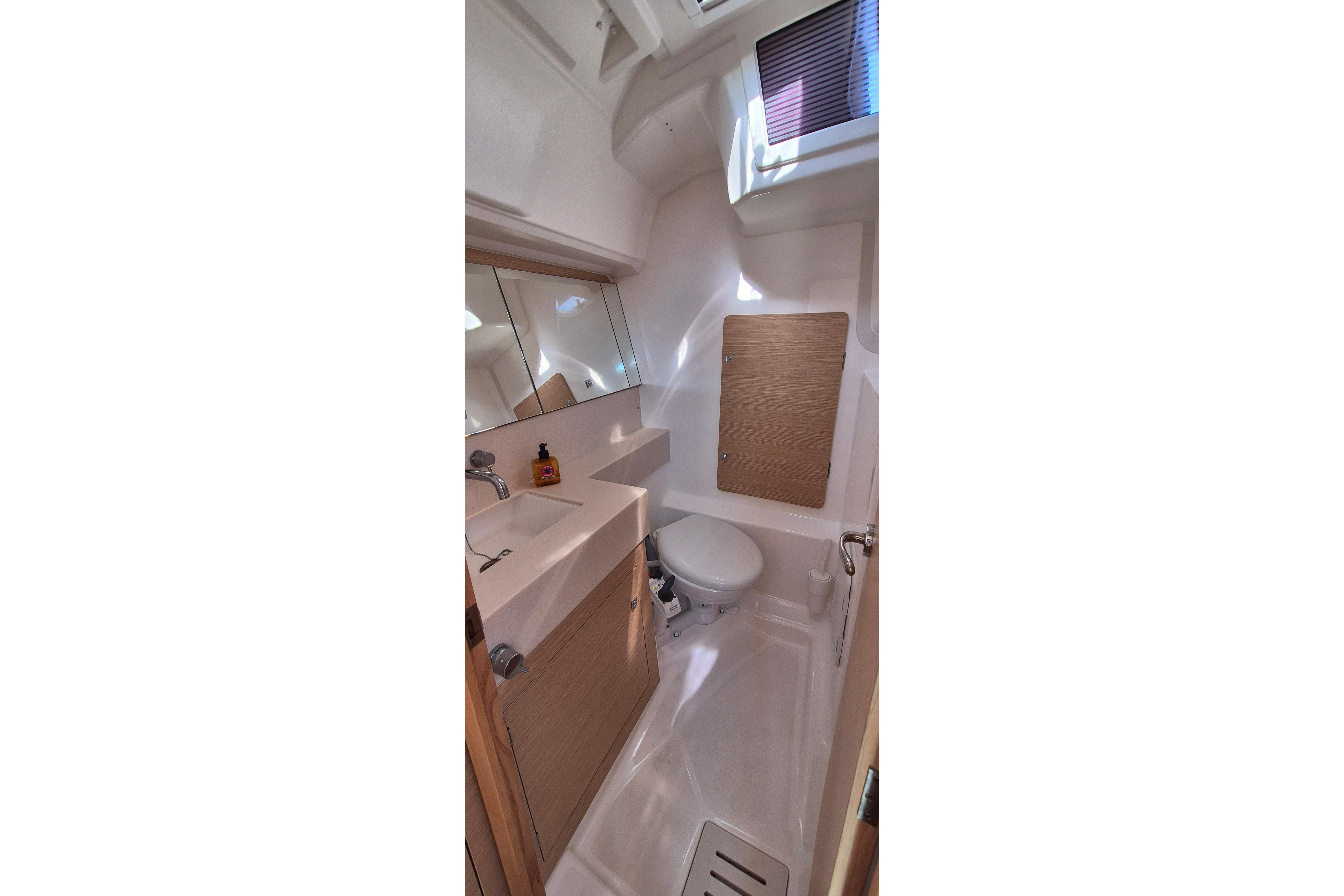 2023 Dufour 37 yacht bathroom with modern fixtures and natural lighting.