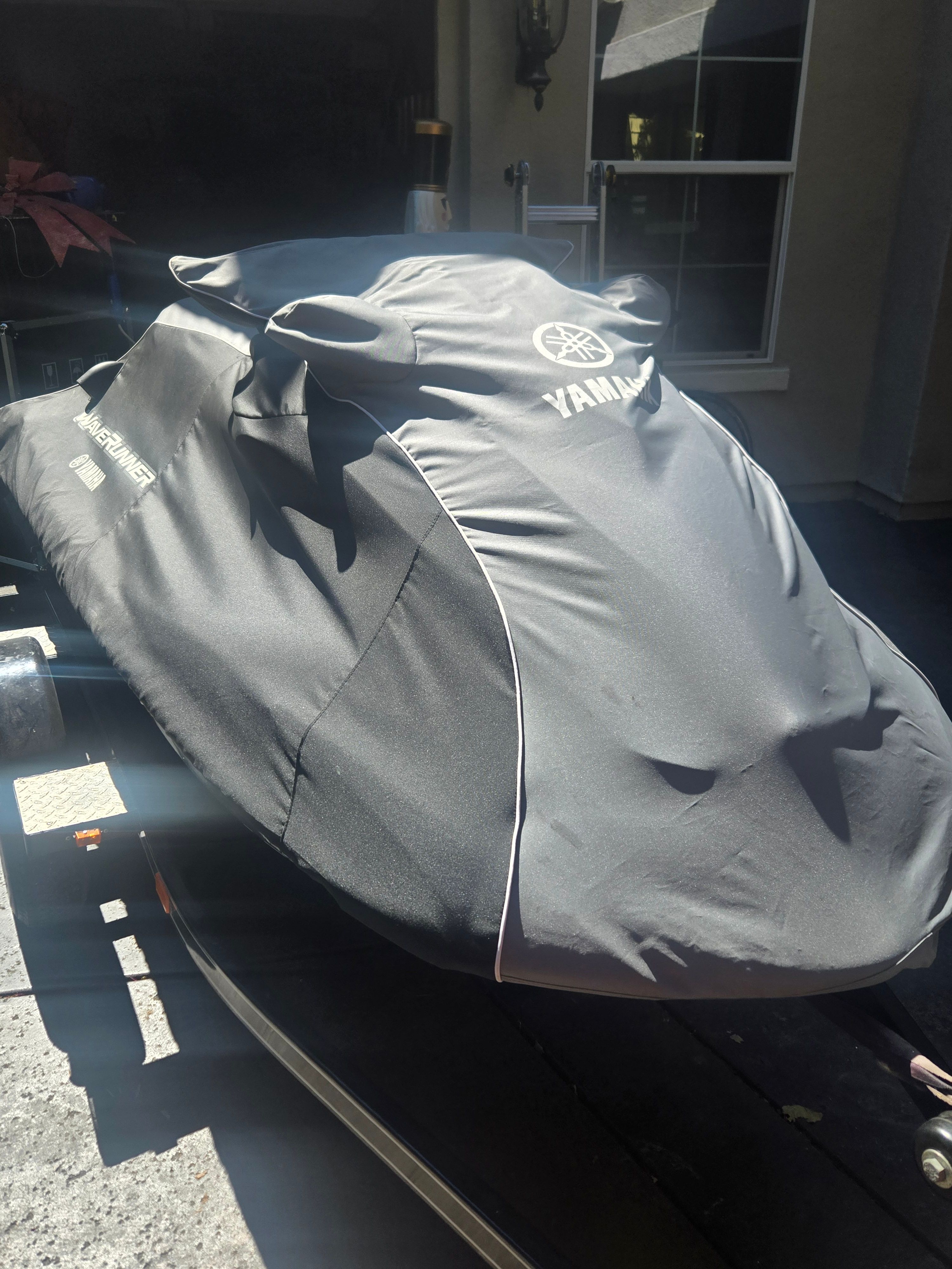 A 2010 Yamaha WaveRunner FZR, covered and on a trailer.