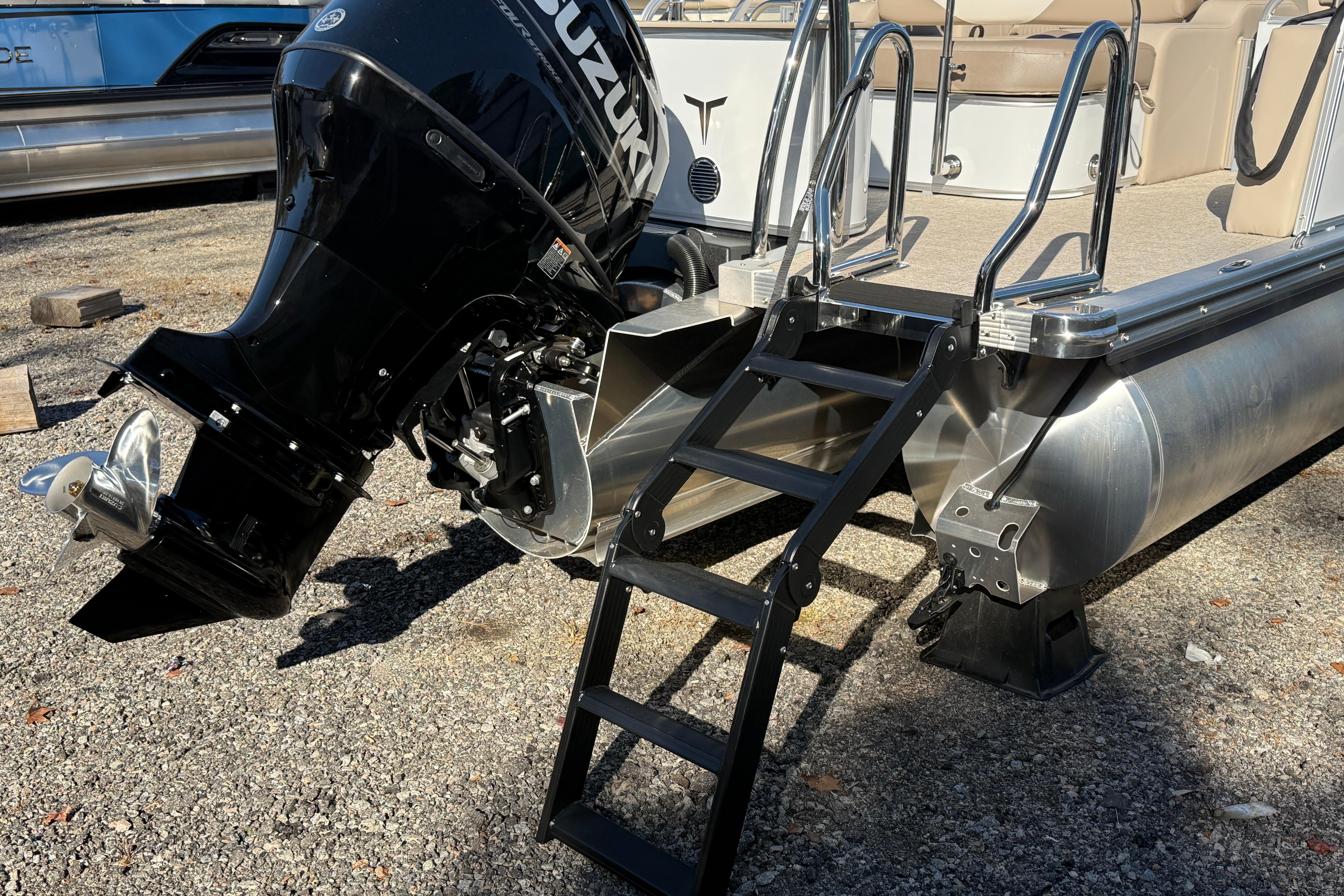 2026 Tahoe Pontoon LTZ Versatile Rear Lounger with Suzuki outboard motor and boarding ladder.