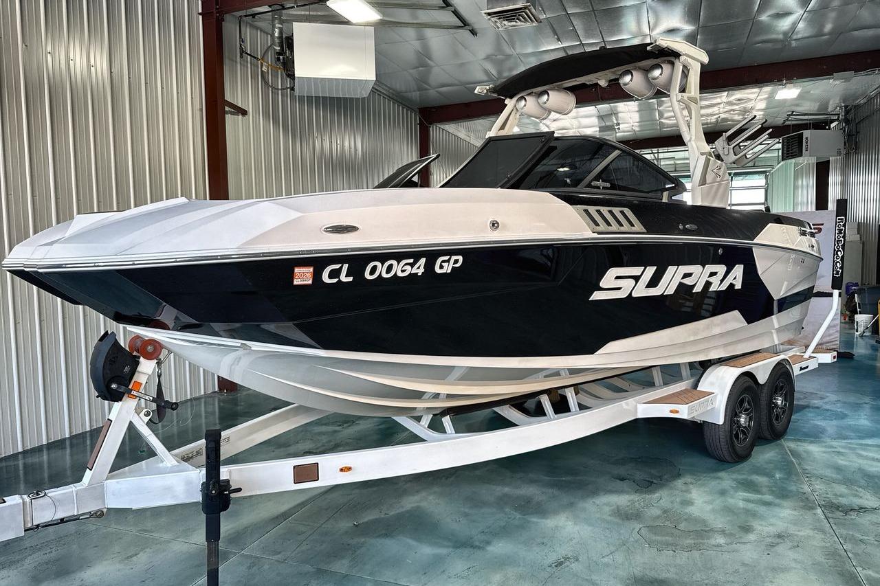 2020 Supra SE boat on trailer in indoor storage facility.