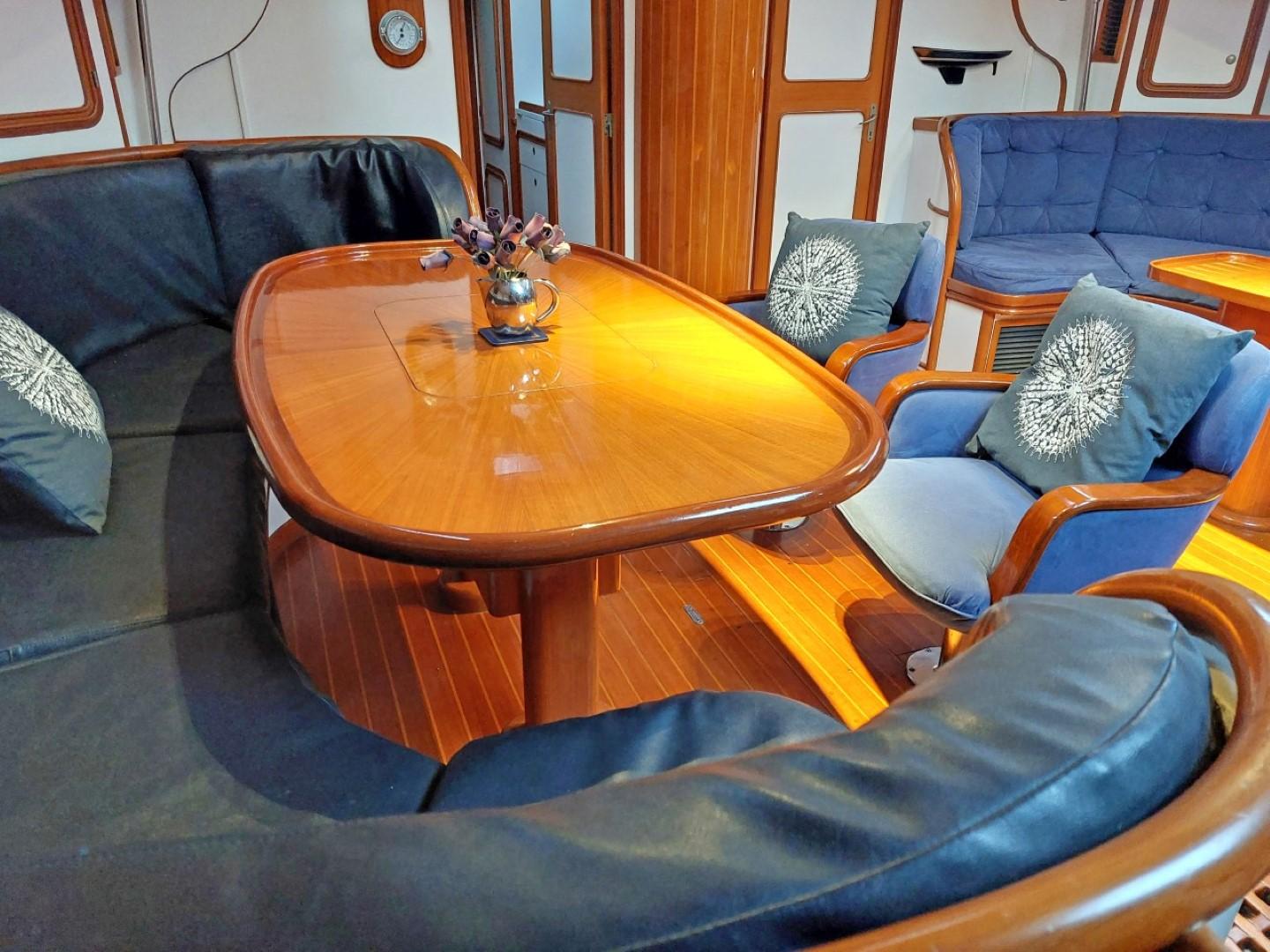 Luxurious interior of a 1990 Mystic 60 yacht with elegant wood furnishings.