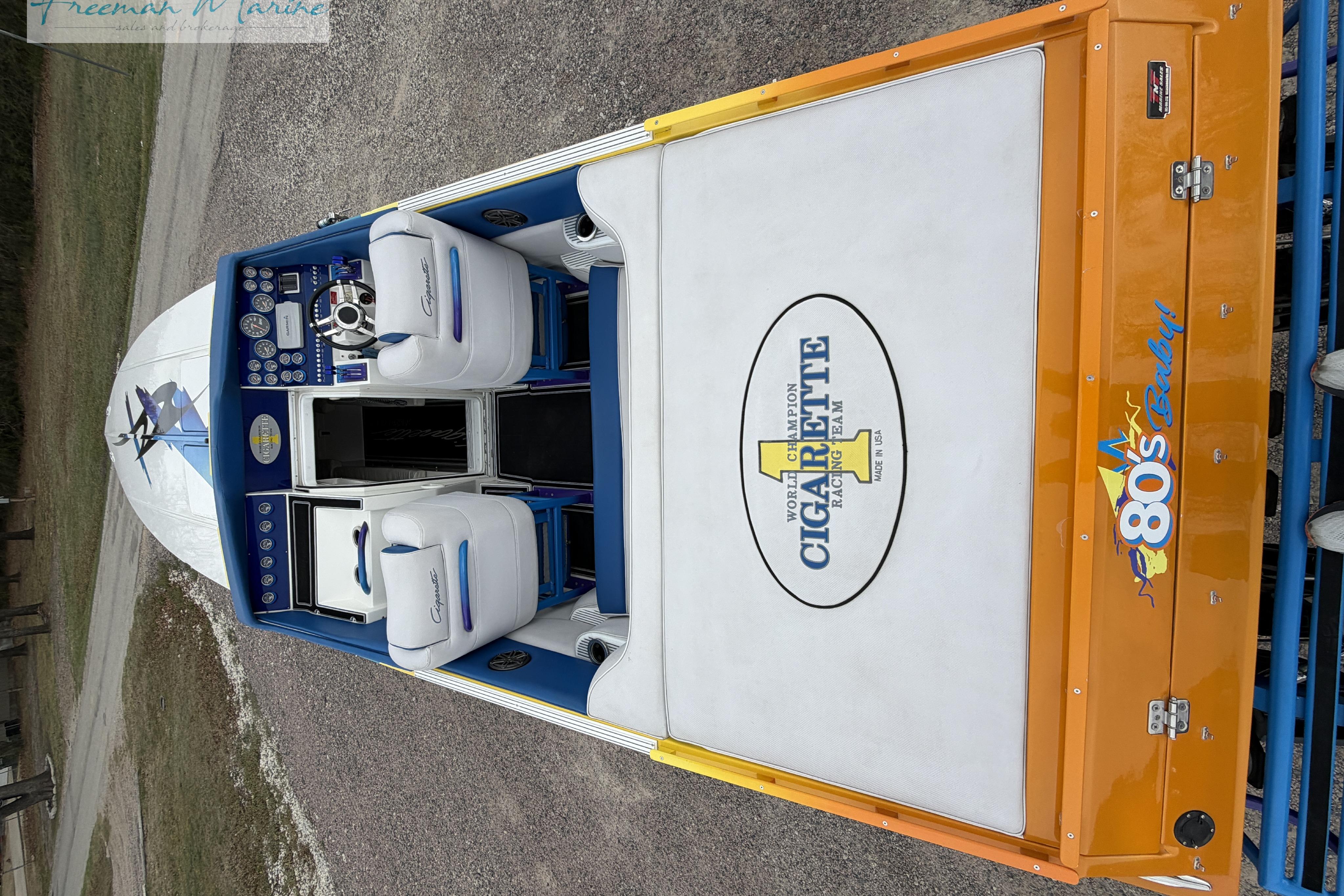 2000 Cigarette 30' Mystique boat interior with white and blue seating, orange accents.