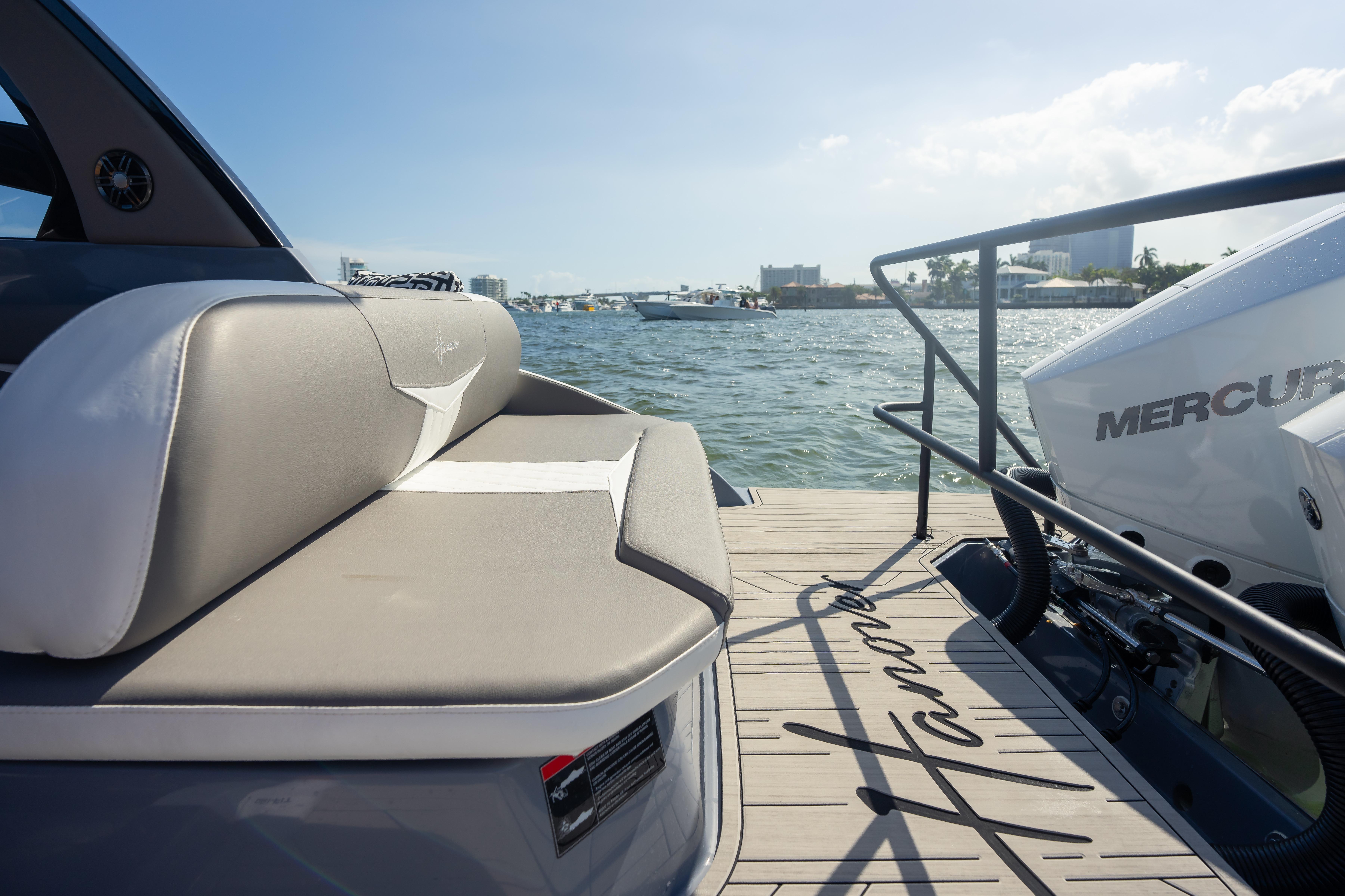 Luxury Hanover 305 boat with Mercury engine, 2026 model, docked by the water.
