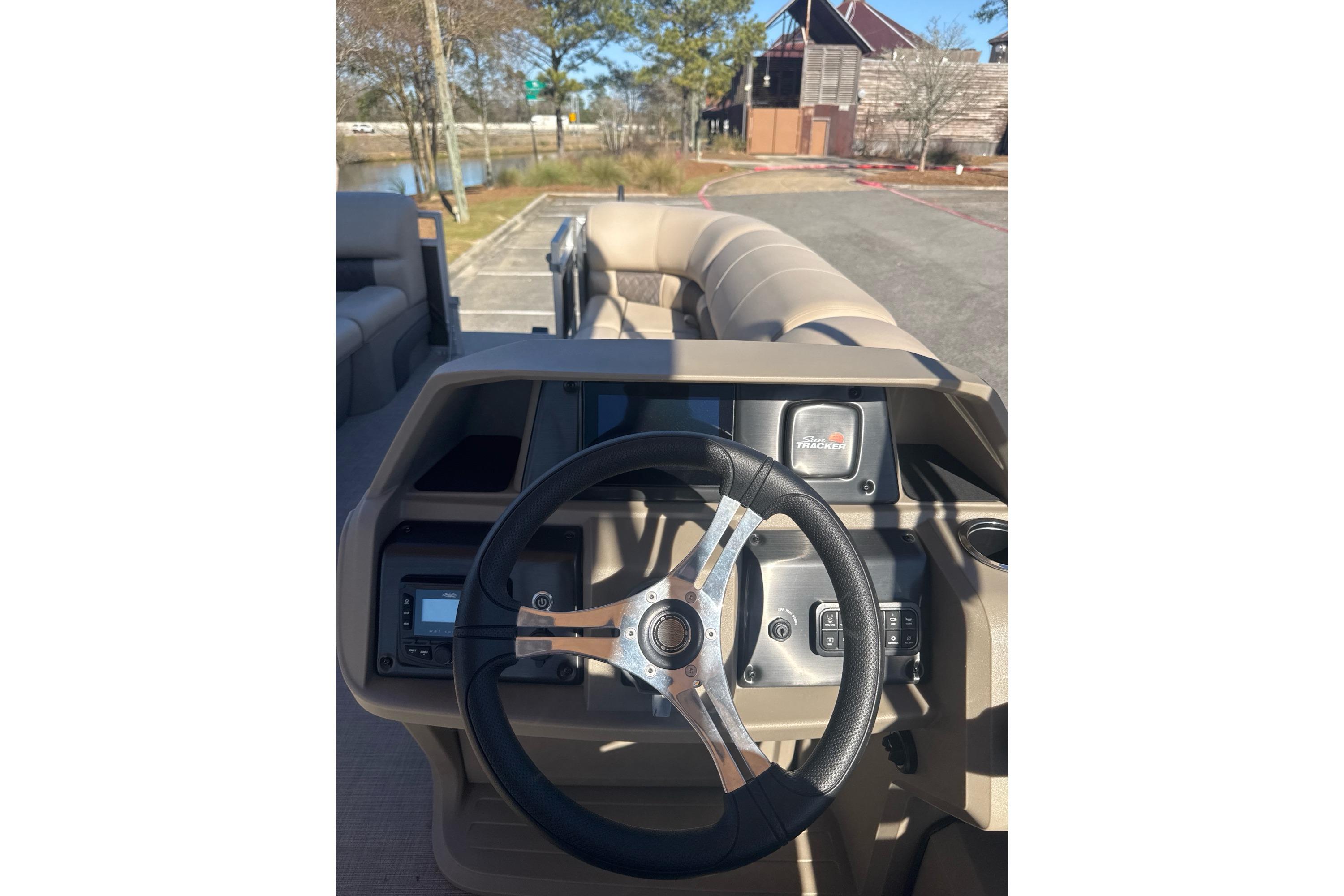 2025 Sun Tracker SportFish 22 DLX steering console with modern controls and dashboard.