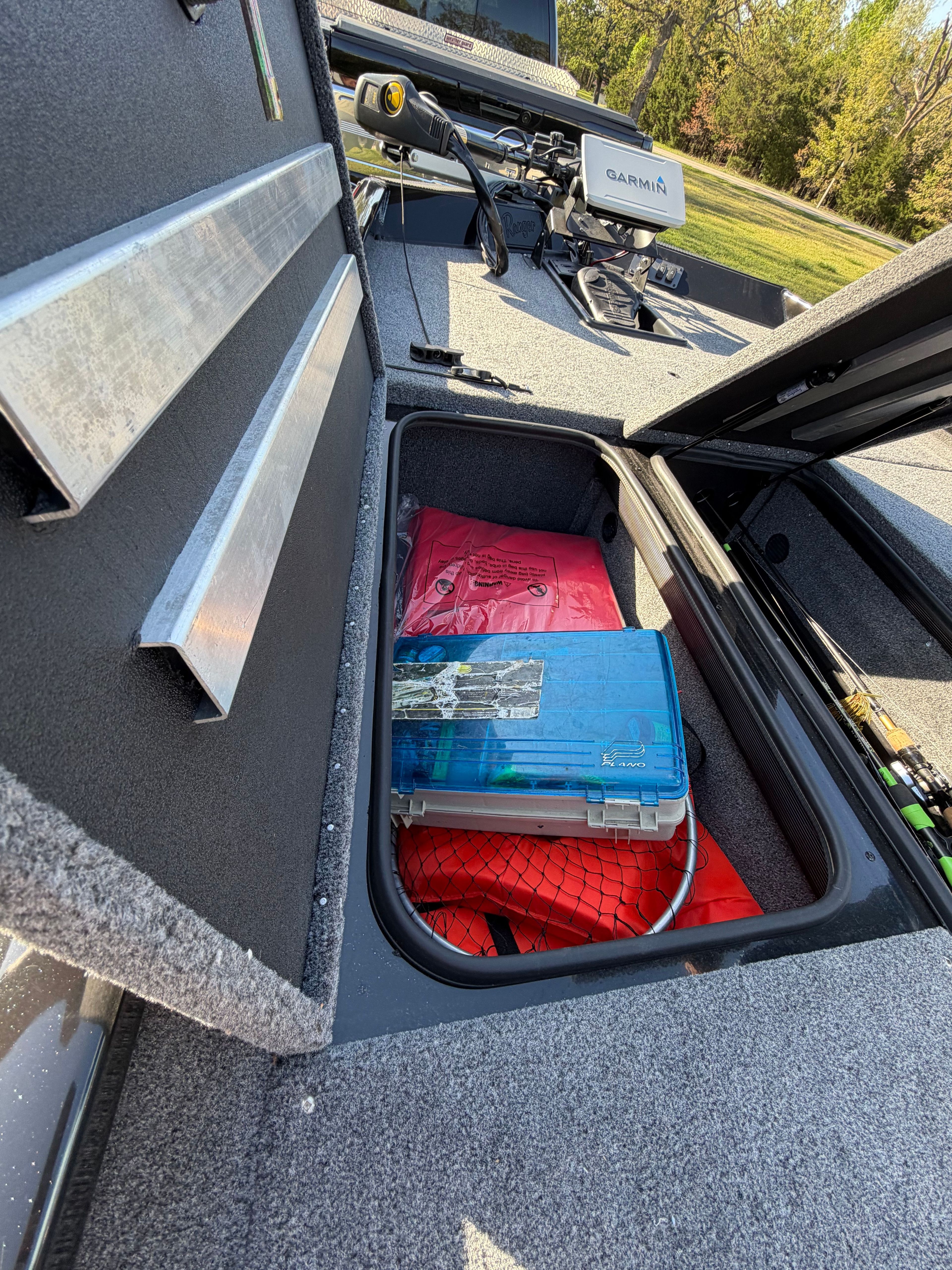 2024 Ranger RT188 boat with storage compartment and fishing gear.