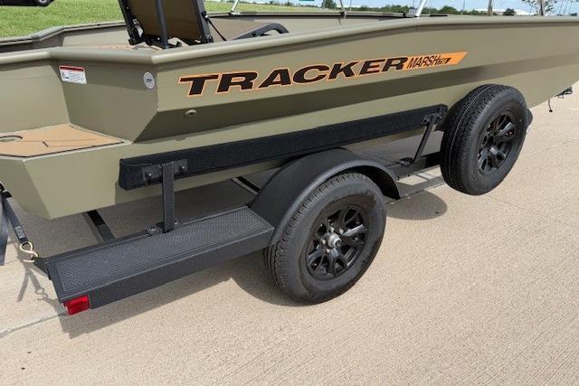 2026 Tracker Grizzly 1756 T Marsh boat on trailer, featuring rugged design and black wheels.