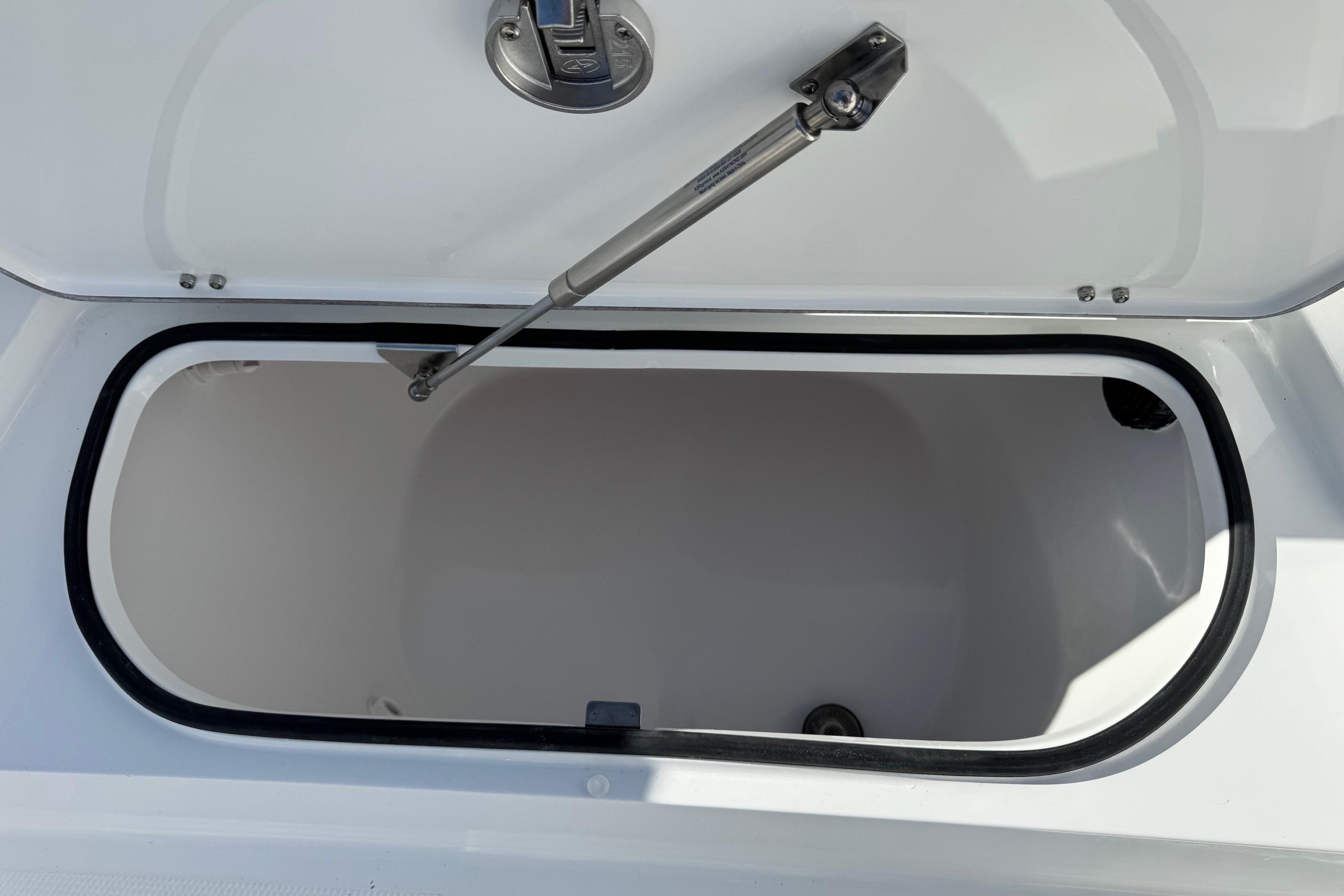 Open storage compartment on 2026 BlackJack 256 Bay boat.