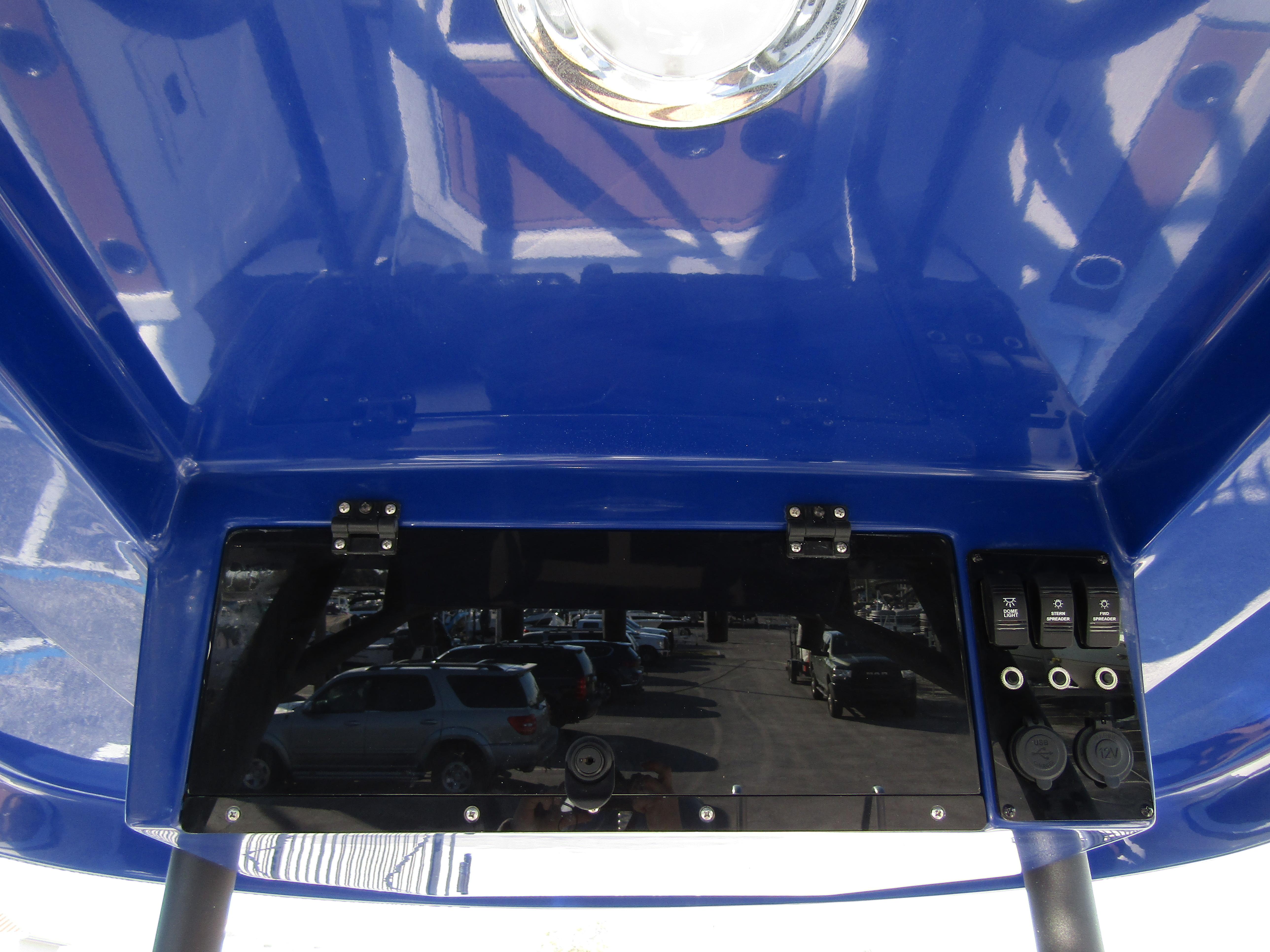 2024 Starcraft SVX 231 OB CC boat console with blue canopy.