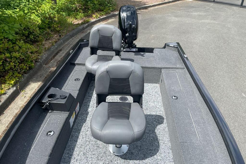 2025 Tracker Super Guide V-16 T boat interior with two gray seats and motor.