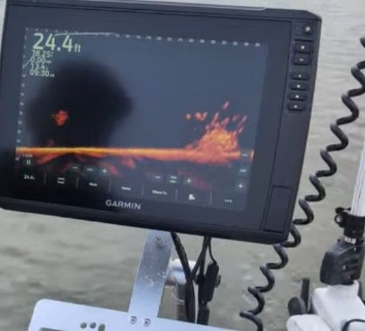 A Garmin fish finder on a boat displays a depth of 24.4 feet.