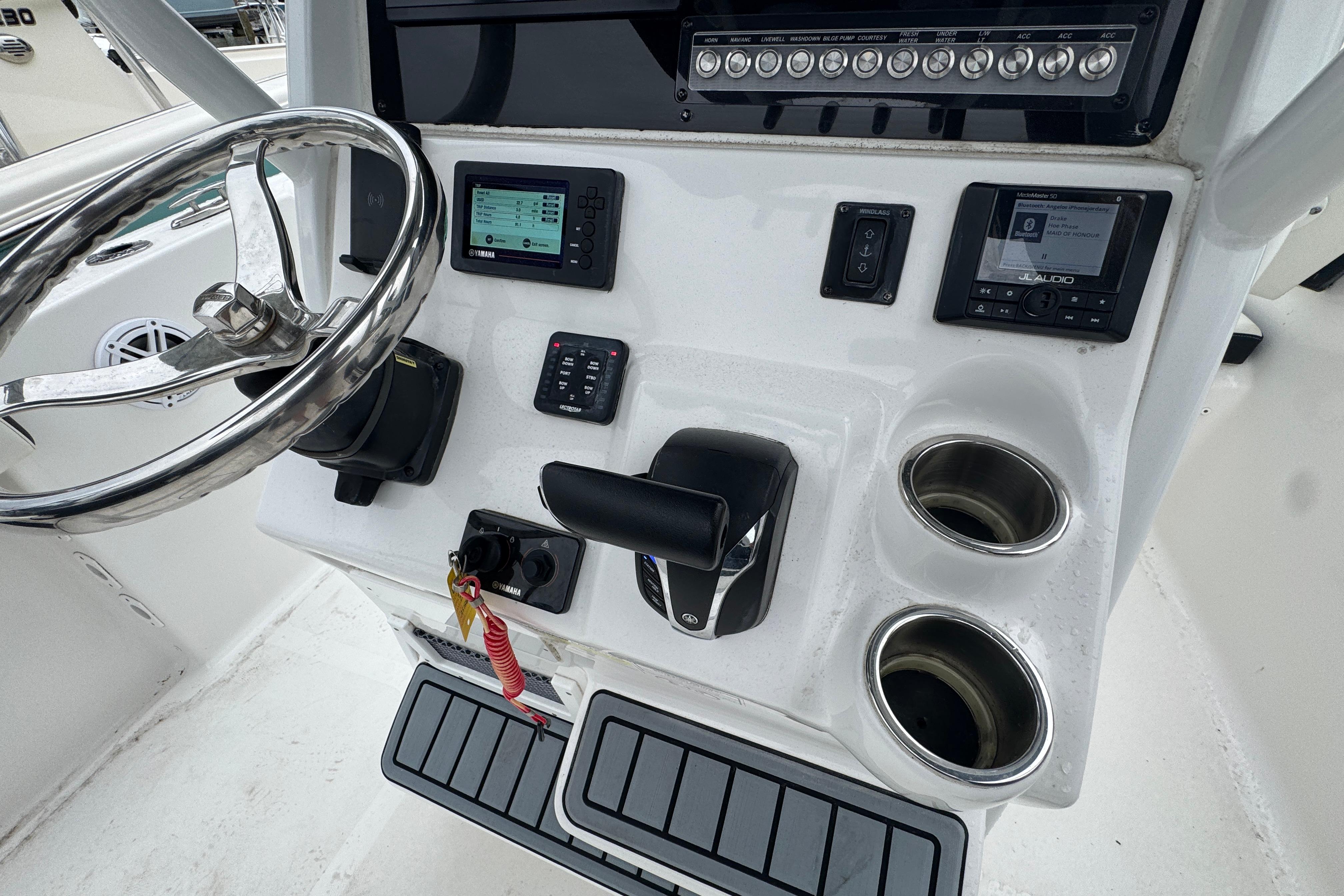 Control panel of 2022 Tidewater 232 SS boat with steering wheel and electronics.