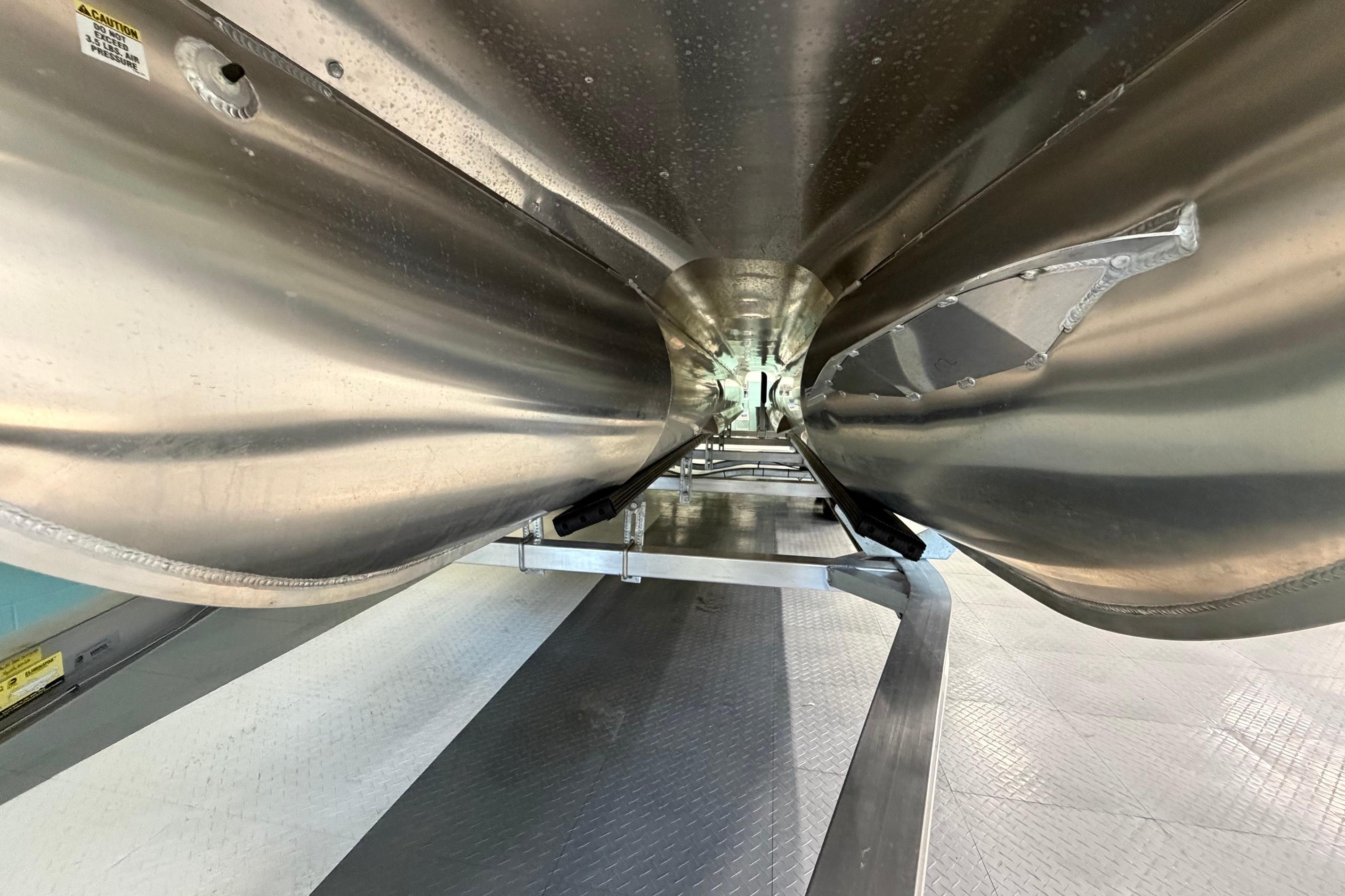 Underneath view of 2026 South Bay 525SB2 pontoon boat, showcasing sleek aluminum construction.