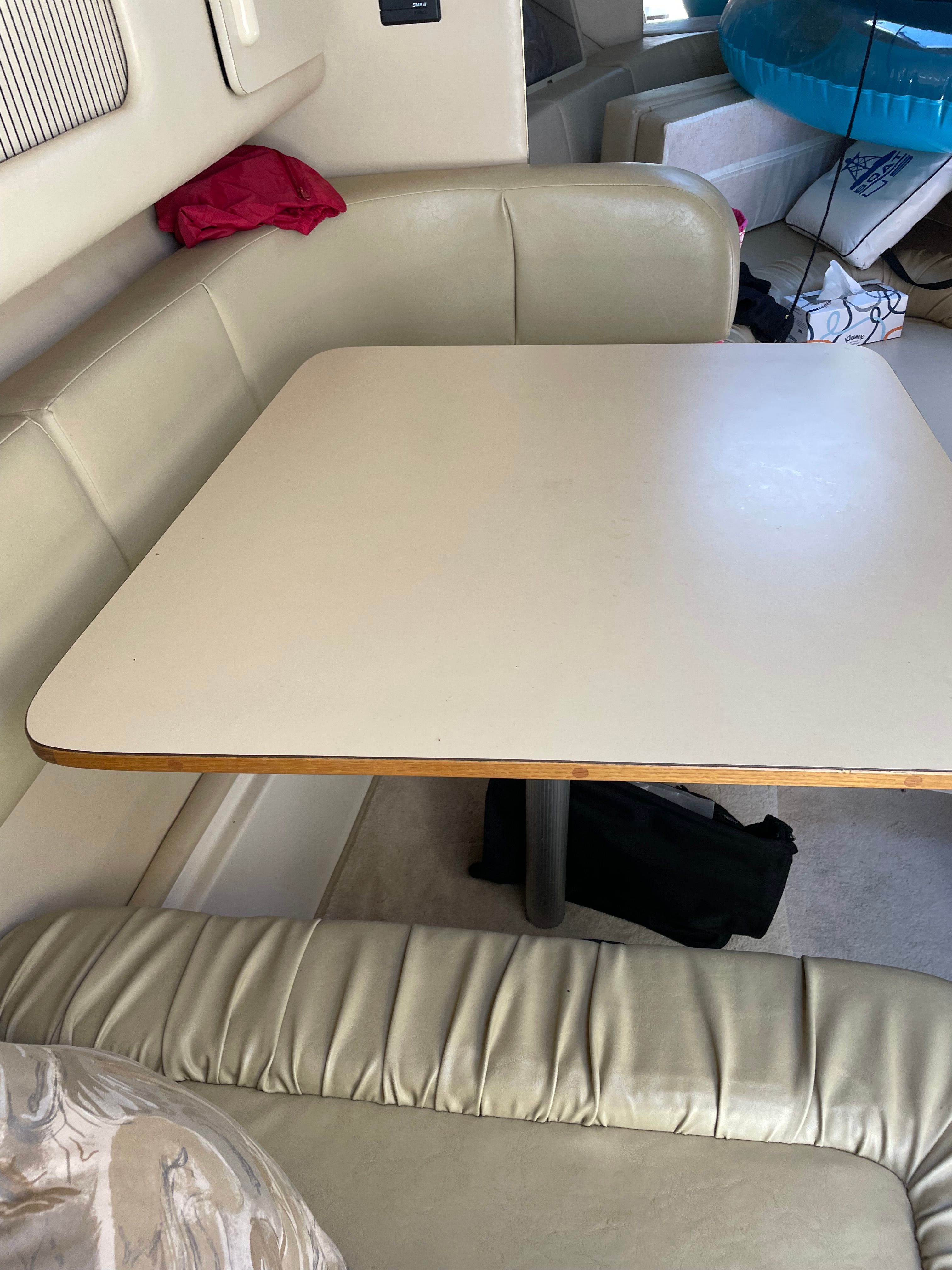 Interior view of a 1998 Sea Ray 270 Sundancer with a table and seating area.