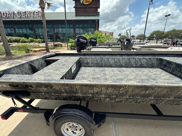 2025 Tracker GRIZZLY 2072 Utility boat on trailer outside a boat center.