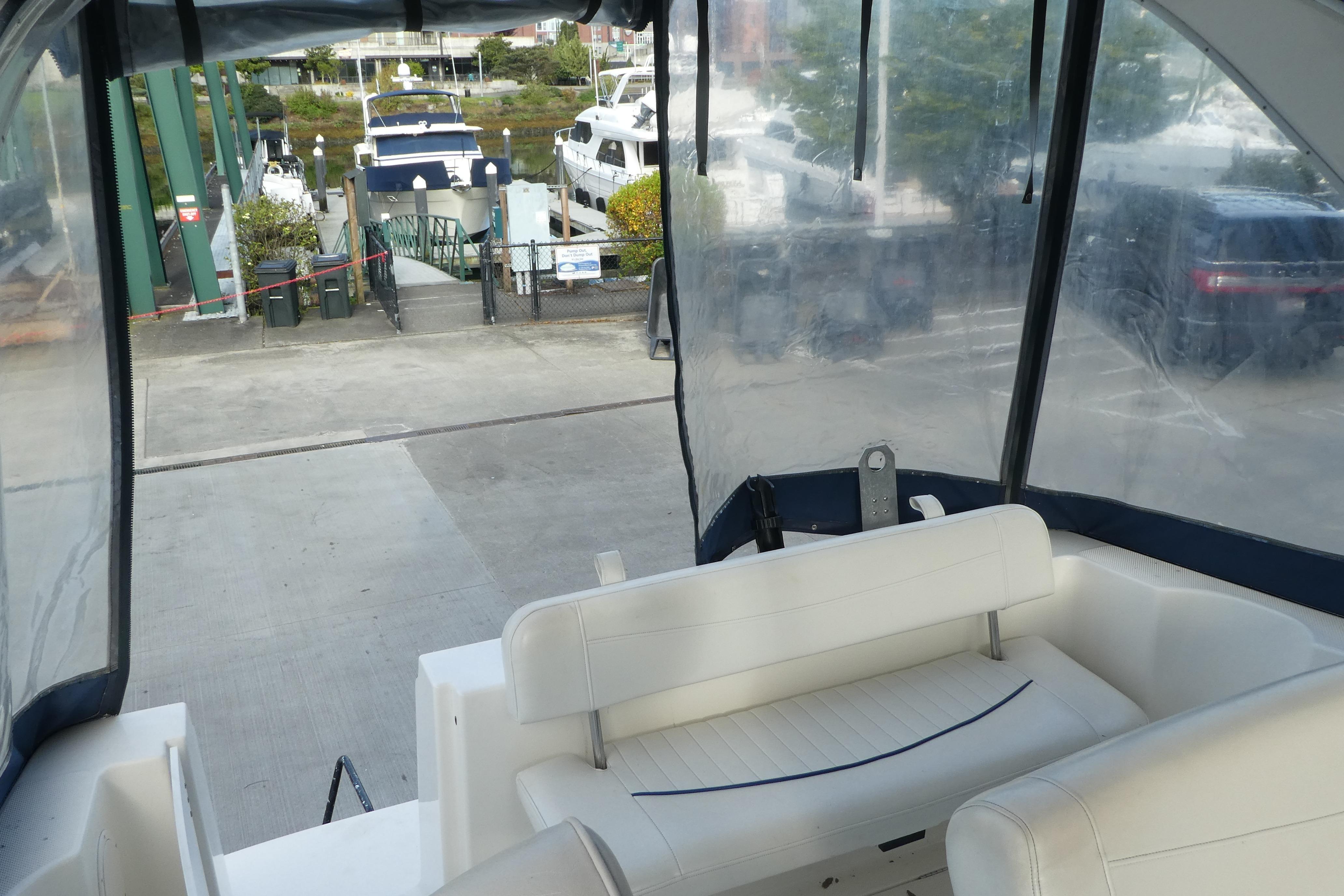 Interior view of a 2002 Bayliner 2855 Ciera boat at a marina dock.