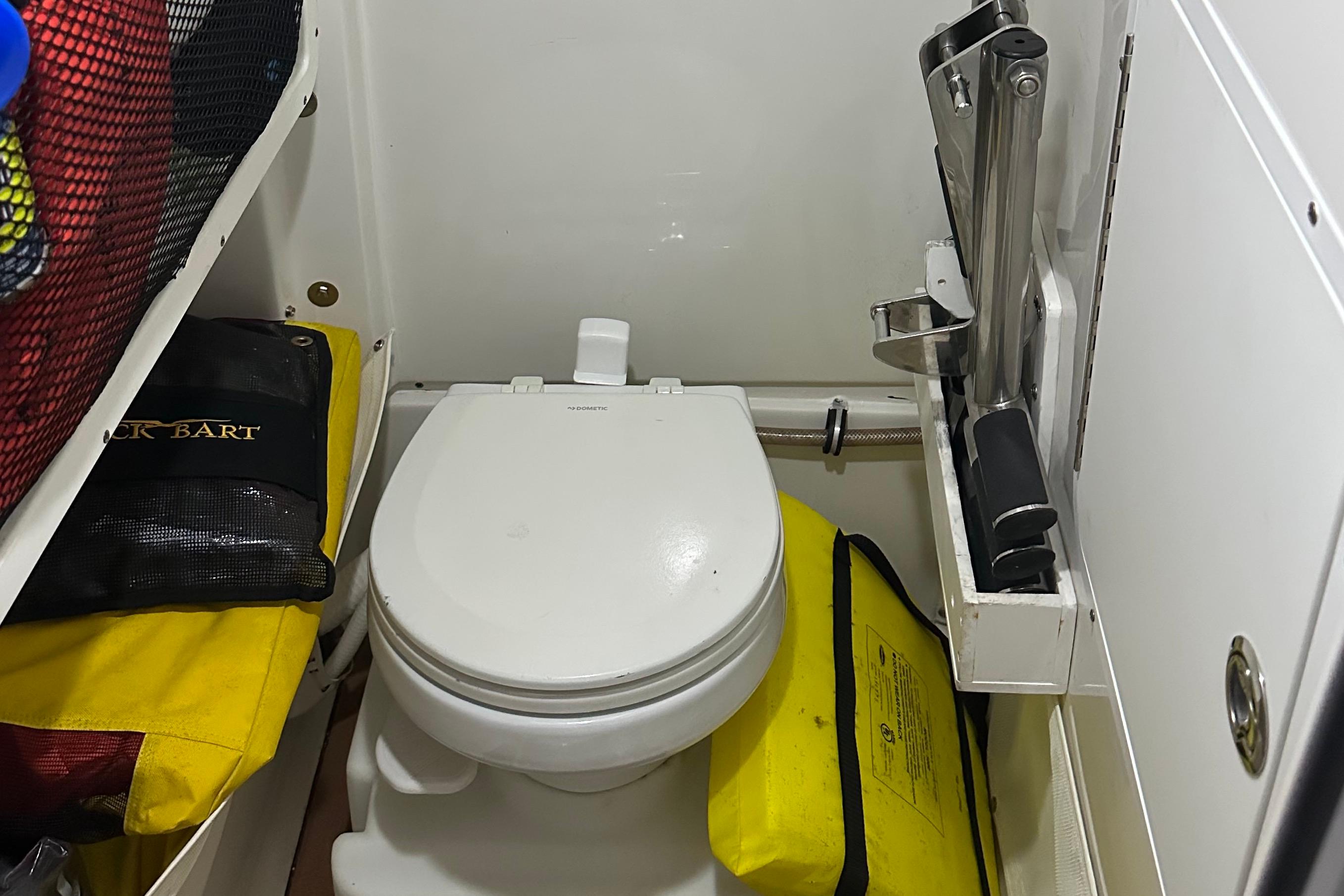 Compact marine toilet in 2019 Sea Hunt Gamefish 25 boat cabin.