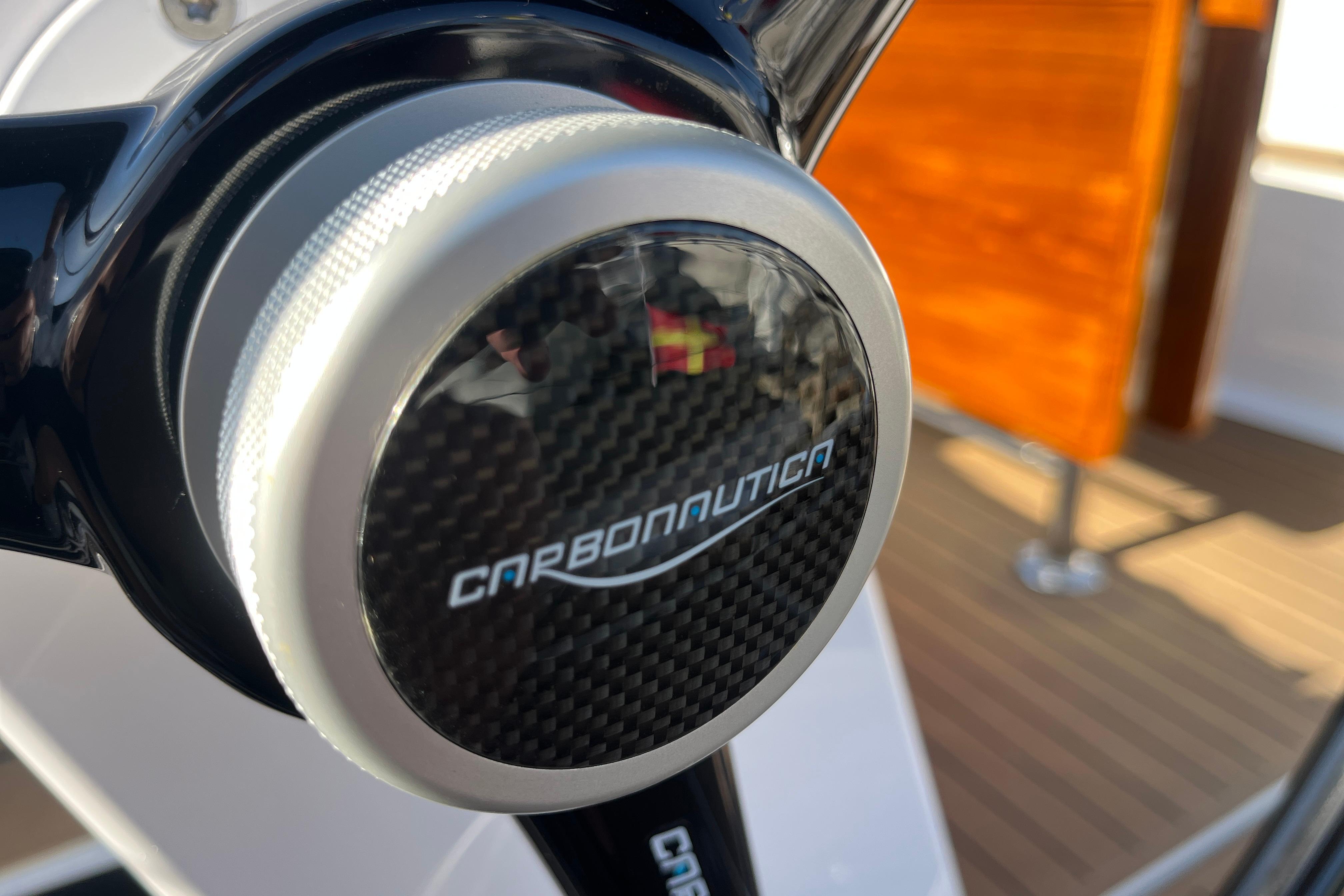 Carbonautica steering wheel detail on 2025 Hanse 360 yacht, featuring sleek carbon fiber design.
