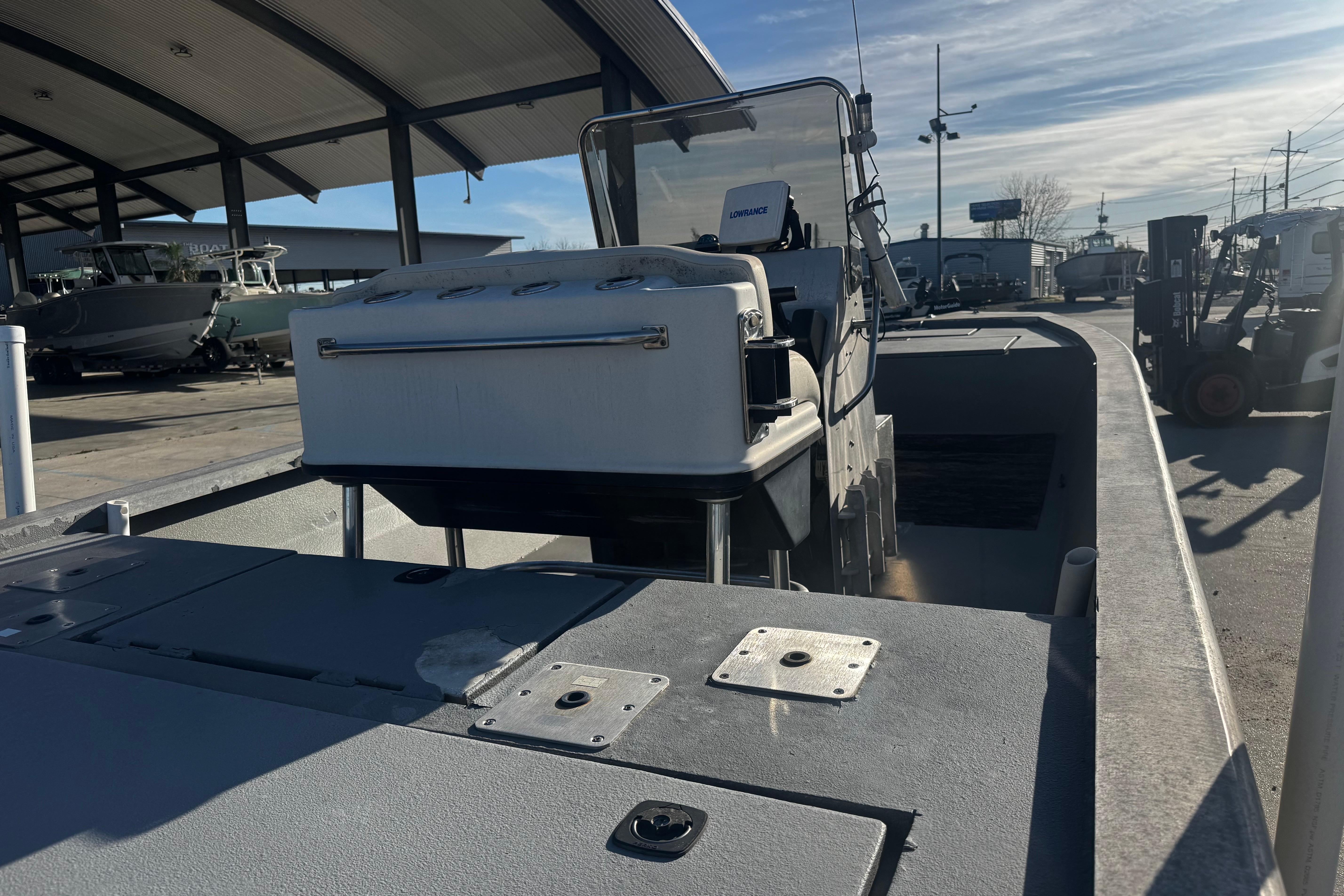 Custom Charles Leonard 21 boat, 2004 model, docked under a covered area.