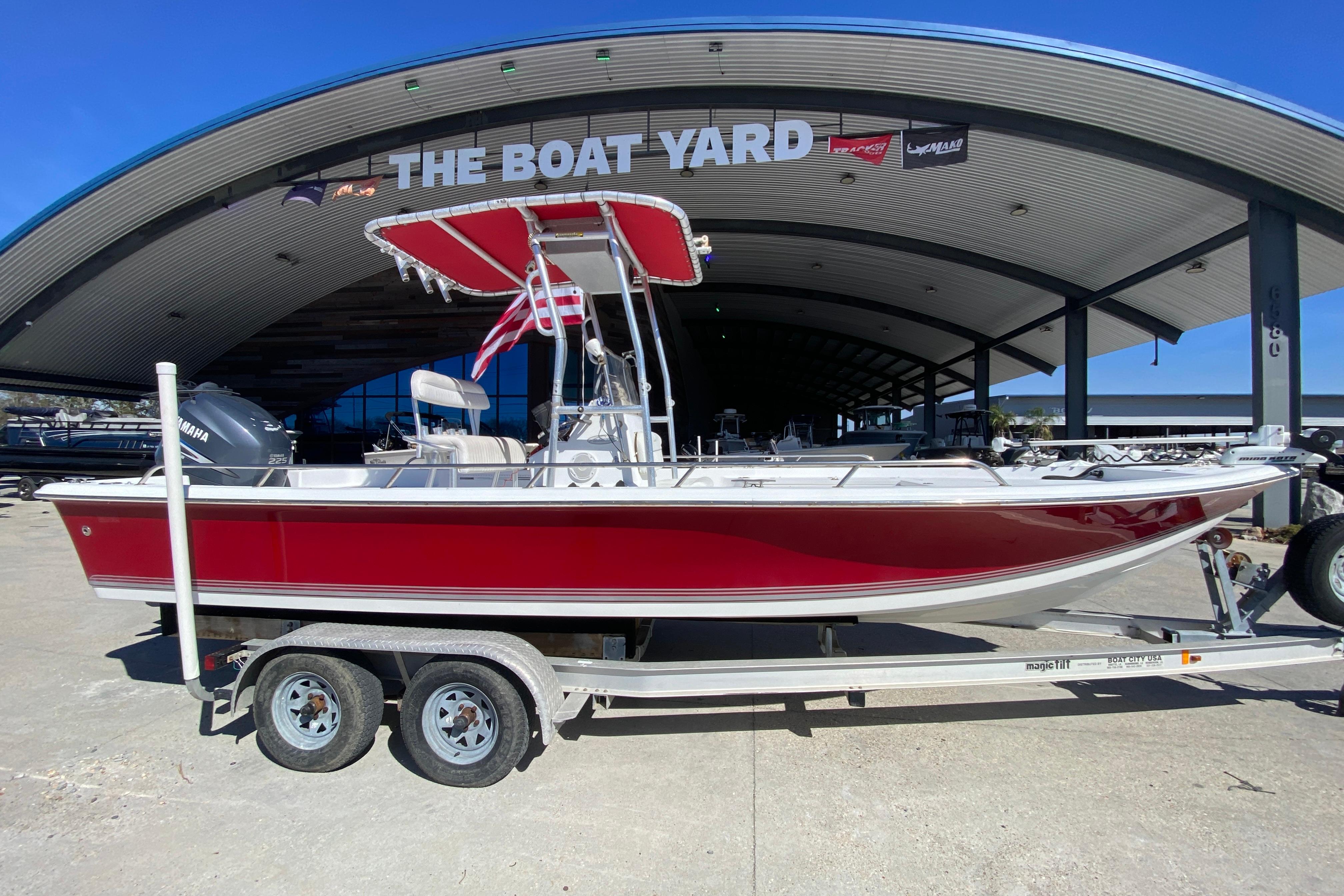 2005 Sea Pro SV2400CC Bay Boat in red, parked at The Boat Yard.