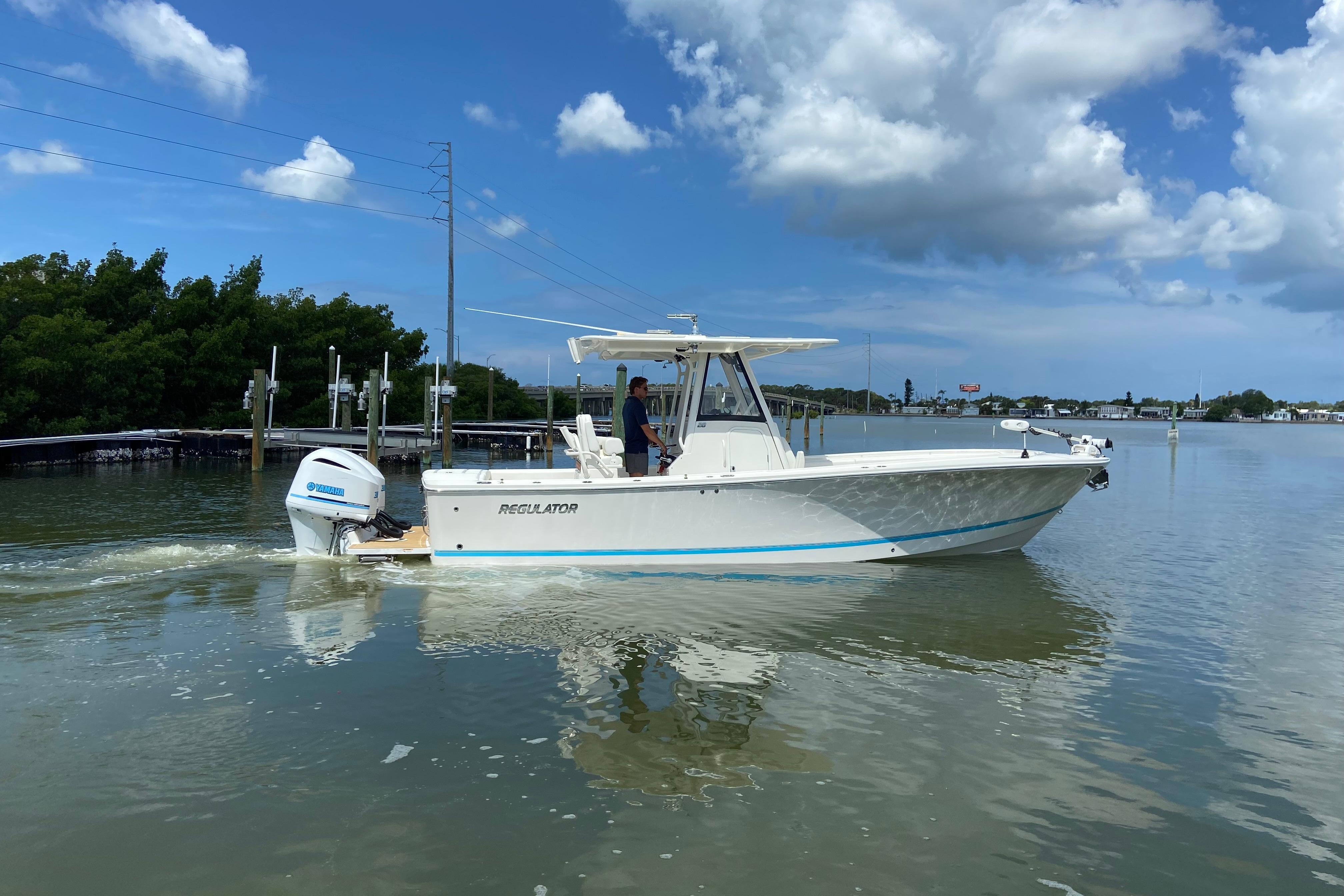 2021 Regulator 28 boat cruising on calm waters under a clear blue sky.