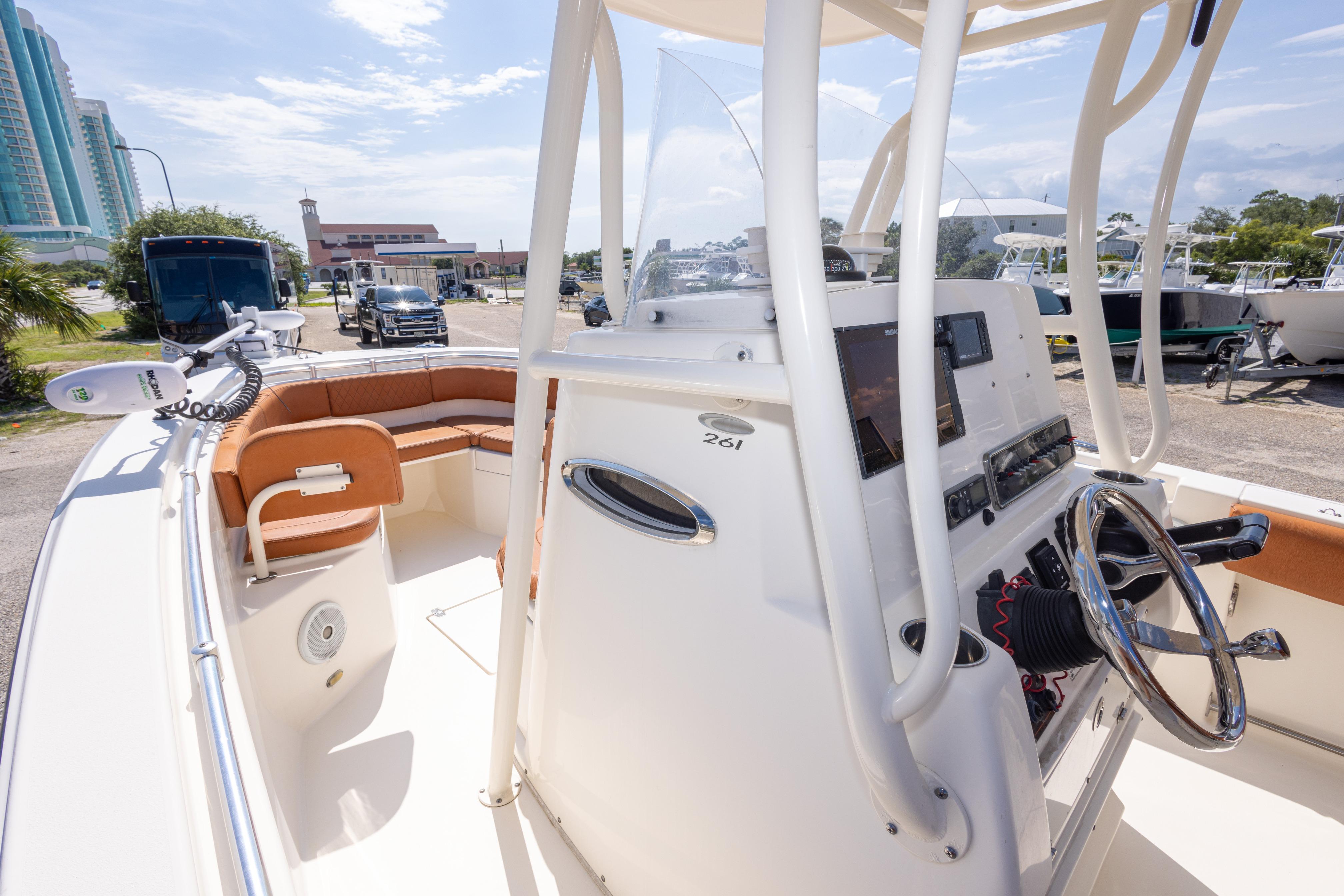 2017 Cobia 261 Center Console boat with modern helm and seating, parked outdoors.
