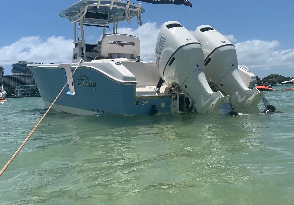 2019 Sea Chaser 27 HFC boat with dual engines in clear water, sunny day.