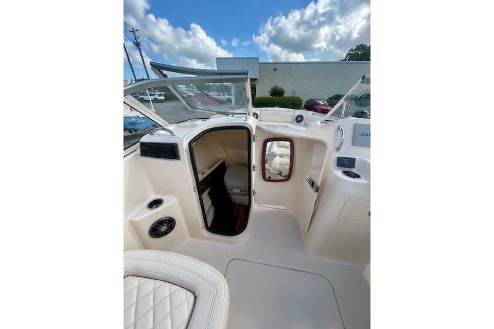 2022 Grady-White Freedom 215 boat interior with open cabin door under a blue sky.