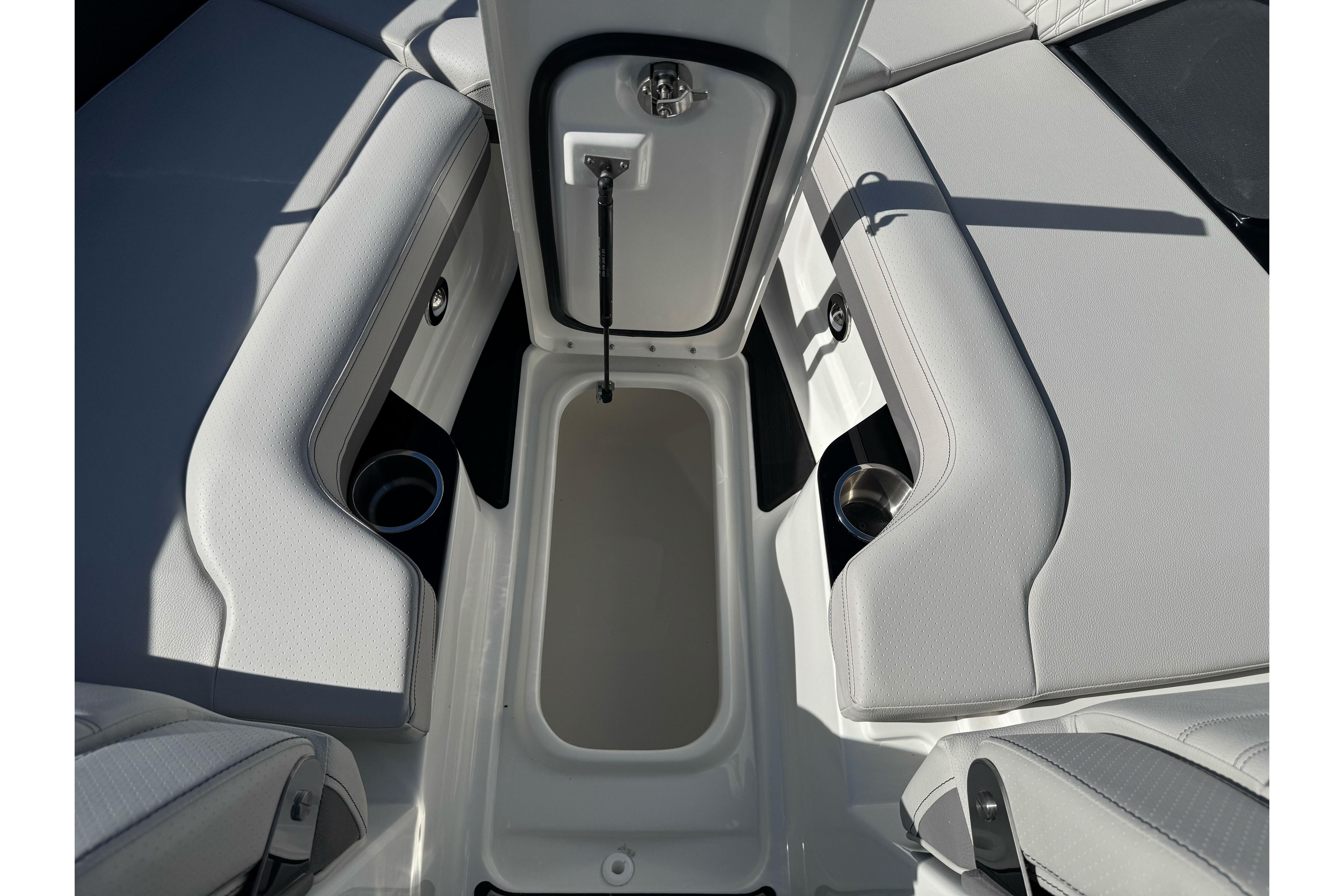 2026 Sea Ray SLX 260 boat interior with open storage compartment and cup holders.