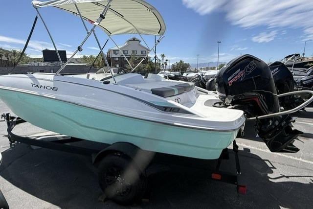 2026 Tahoe T18 boat with canopy and outboard motor on trailer.