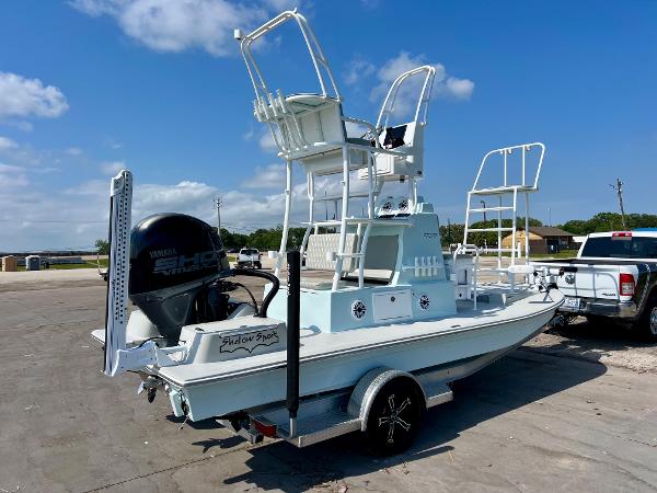 2022 Shallow Sport 20 Classic boat with elevated seating, parked on a trailer under a clear sky.